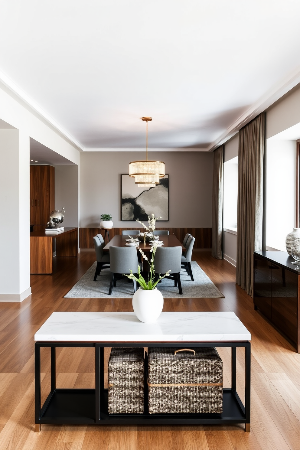 A stylish open floor plan dining room features a sleek console table positioned against the wall for extra storage. The dining area includes a large wooden table surrounded by upholstered chairs, with a modern chandelier hanging above to create an inviting atmosphere.