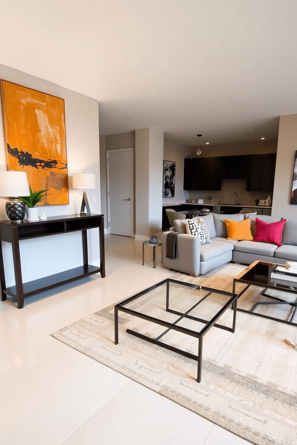 A stylish entryway features a sleek console table made of dark wood, adorned with a decorative lamp and a small potted plant. The wall above the table is decorated with a large abstract painting that adds a pop of color to the space. The open floor plan living room boasts a spacious layout with a comfortable sectional sofa in a soft gray fabric, complemented by vibrant throw pillows. A large area rug anchors the seating area, while a modern coffee table made of glass and metal sits at the center, enhancing the room's contemporary feel.