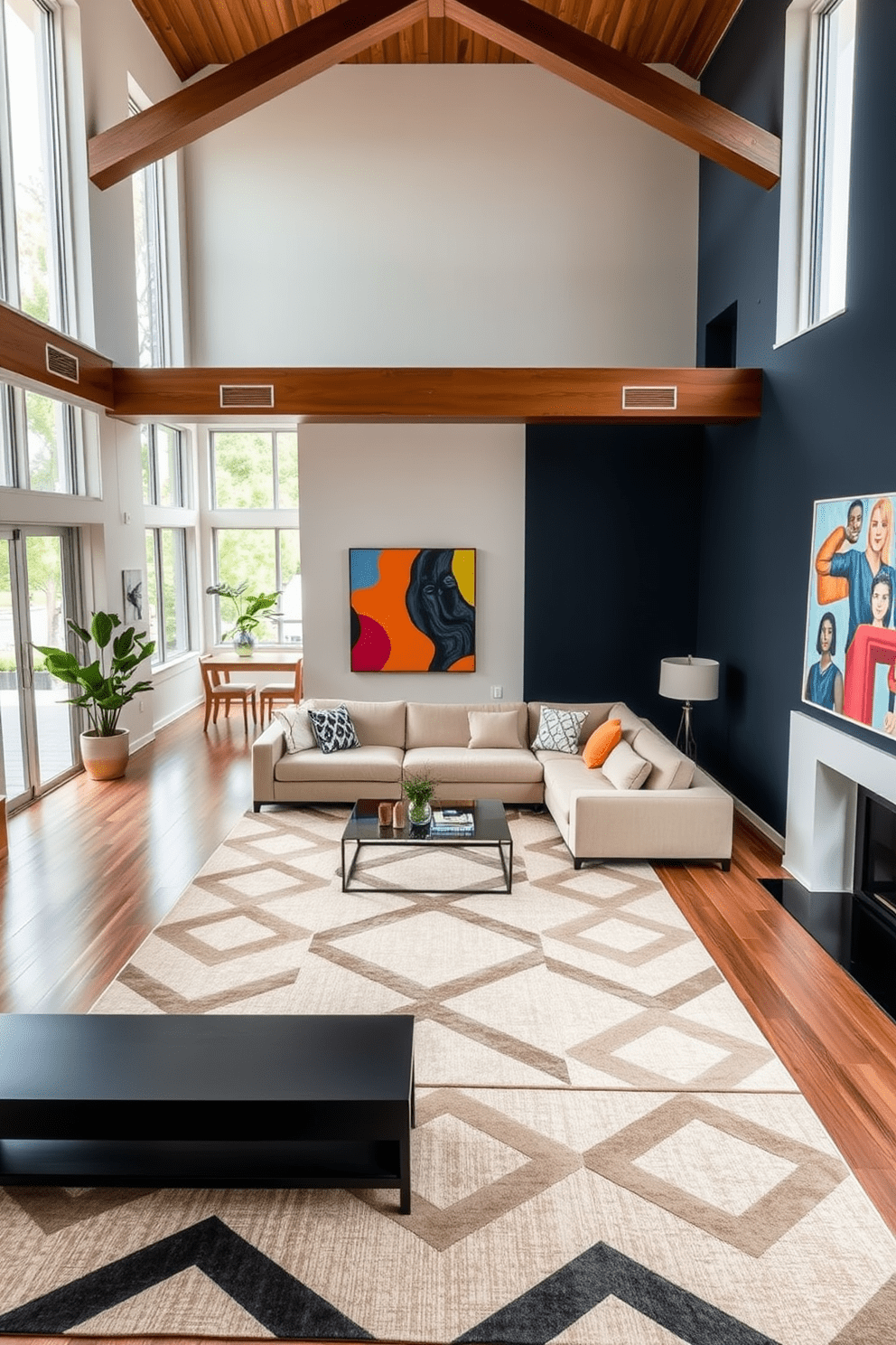 A spacious open floor plan living room with a modern aesthetic. The area is divided using contrasting colors, with a deep navy blue accent wall that complements the light beige sofa. A large area rug in a bold geometric pattern anchors the seating area, creating a cozy yet stylish atmosphere. Floor-to-ceiling windows allow natural light to flood the space, highlighting the vibrant artwork on the walls.