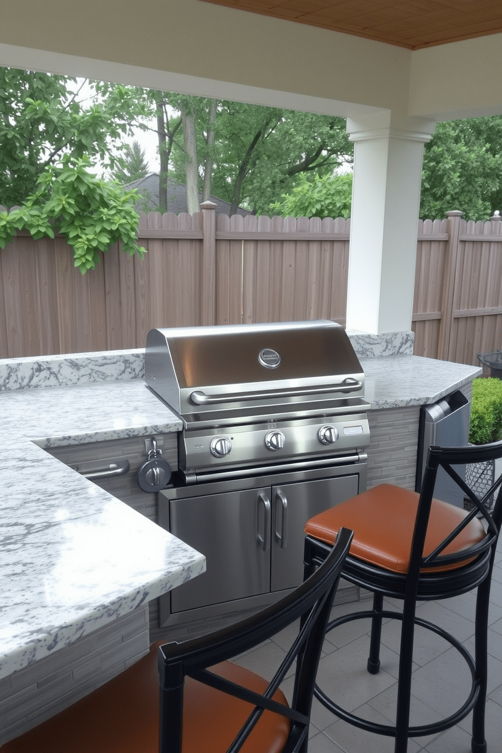 A built-in grill station is the centerpiece of this outdoor kitchen, featuring a sleek stainless steel grill and ample countertop space for food preparation. Surrounding the grill, the countertops are made of polished granite, complemented by stylish bar stools for casual dining.