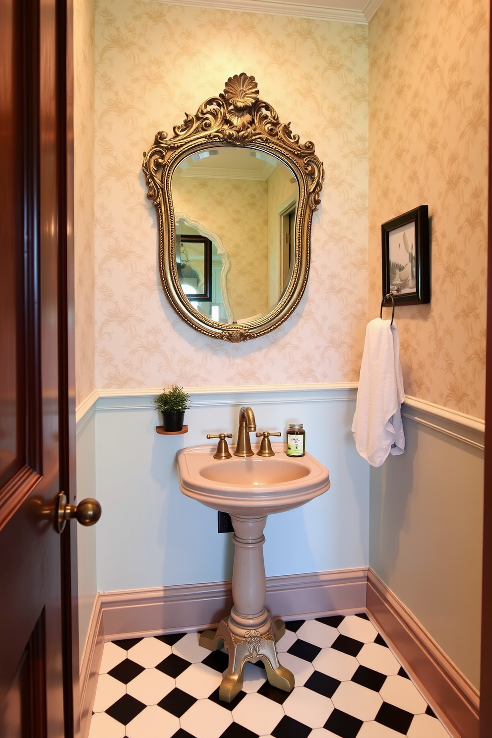 A vintage mirror with an ornate frame is the centerpiece of a charming powder room. The walls are adorned with soft pastel wallpaper, and the floor features classic black and white checkered tiles. A small pedestal sink with a polished brass faucet complements the mirror beautifully. Decorative elements like a small potted plant and elegant hand towels add a touch of sophistication to the space.