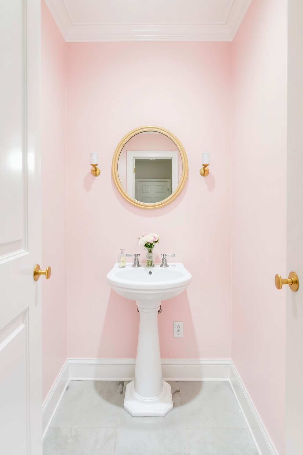 A serene powder room featuring soft pastel tones that create a calming ambiance. The walls are painted in a gentle blush pink, complemented by a white pedestal sink and a round mirror framed in light wood. The flooring is a light gray tile, enhancing the airy feel of the space. Delicate floral accents in the decor, such as a small vase of fresh flowers, add a touch of elegance and warmth.