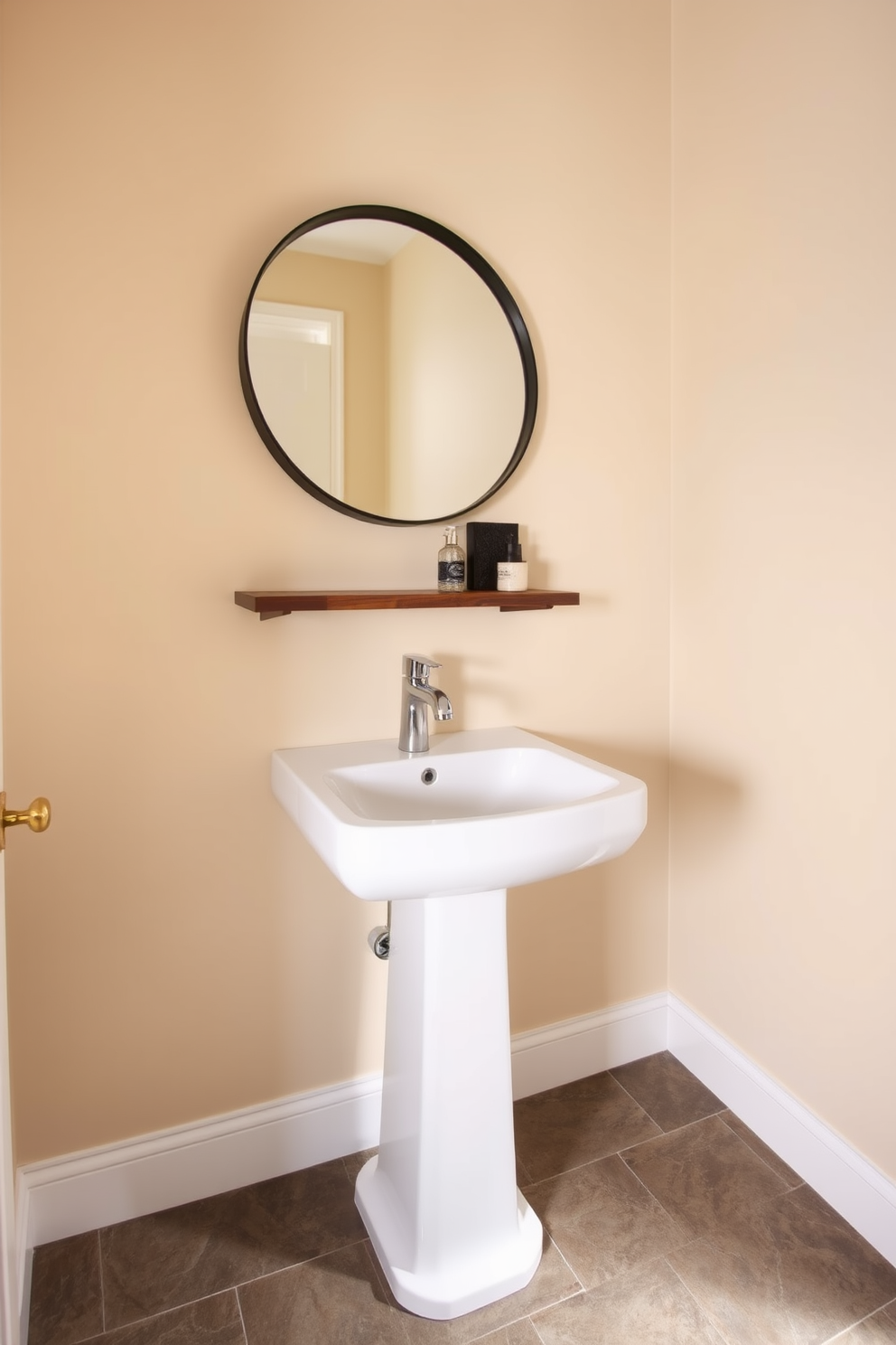 A stylish powder room featuring natural slate tiles that provide an earthy appeal. The walls are painted in soft beige, creating a warm contrast with the textured slate flooring. A sleek white pedestal sink is positioned against the wall, complemented by a modern chrome faucet. Above the sink, a round mirror with a simple black frame enhances the room's elegance. A small wooden shelf holds decorative items, adding a personal touch to the space. Soft, warm lighting illuminates the room, creating an inviting atmosphere.