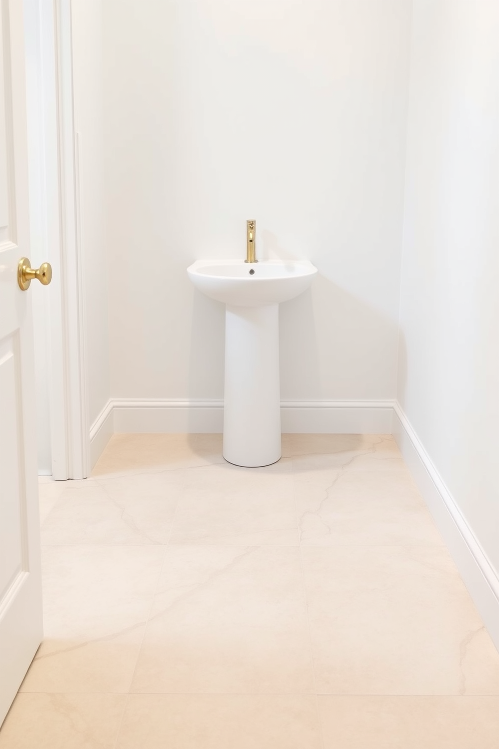 A serene powder room featuring neutral-toned tiles that create a calming atmosphere. The floor is adorned with large, soft beige tiles complemented by delicate gray veining for an elegant touch. The walls are painted in a soft white hue, enhancing the light and airy feel of the space. A sleek, modern pedestal sink sits against the wall, paired with a minimalist gold faucet for a touch of luxury.