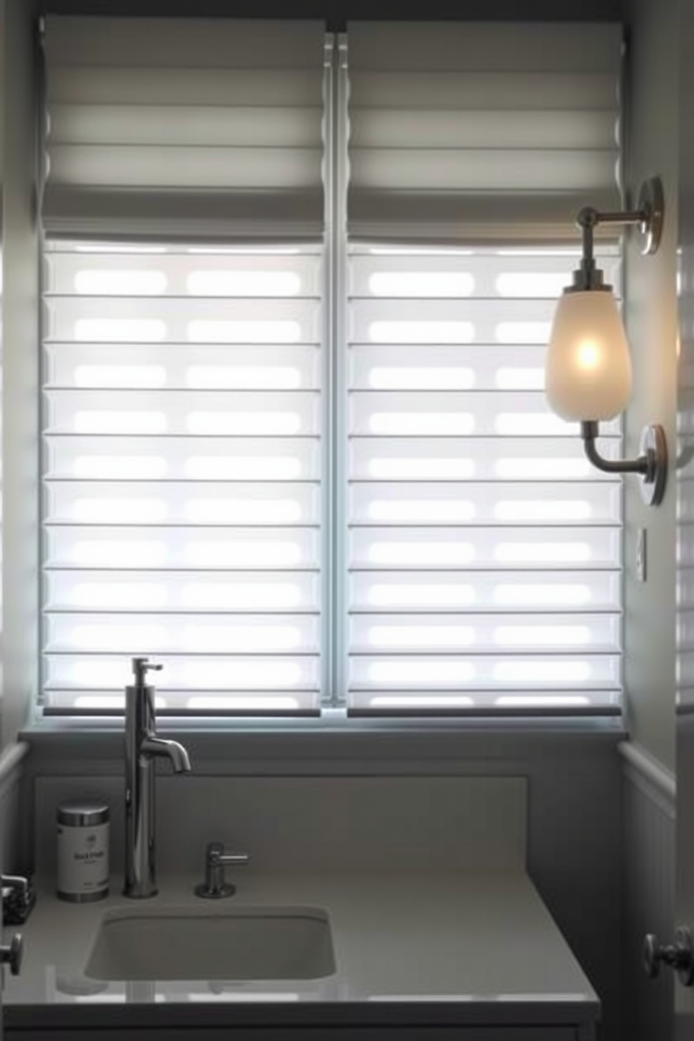 A stylish powder room features translucent shades that softly diffuse natural light, creating a warm and inviting atmosphere. The elegant fixtures are complemented by a chic vanity with a sleek design, enhancing the overall aesthetic of the space.