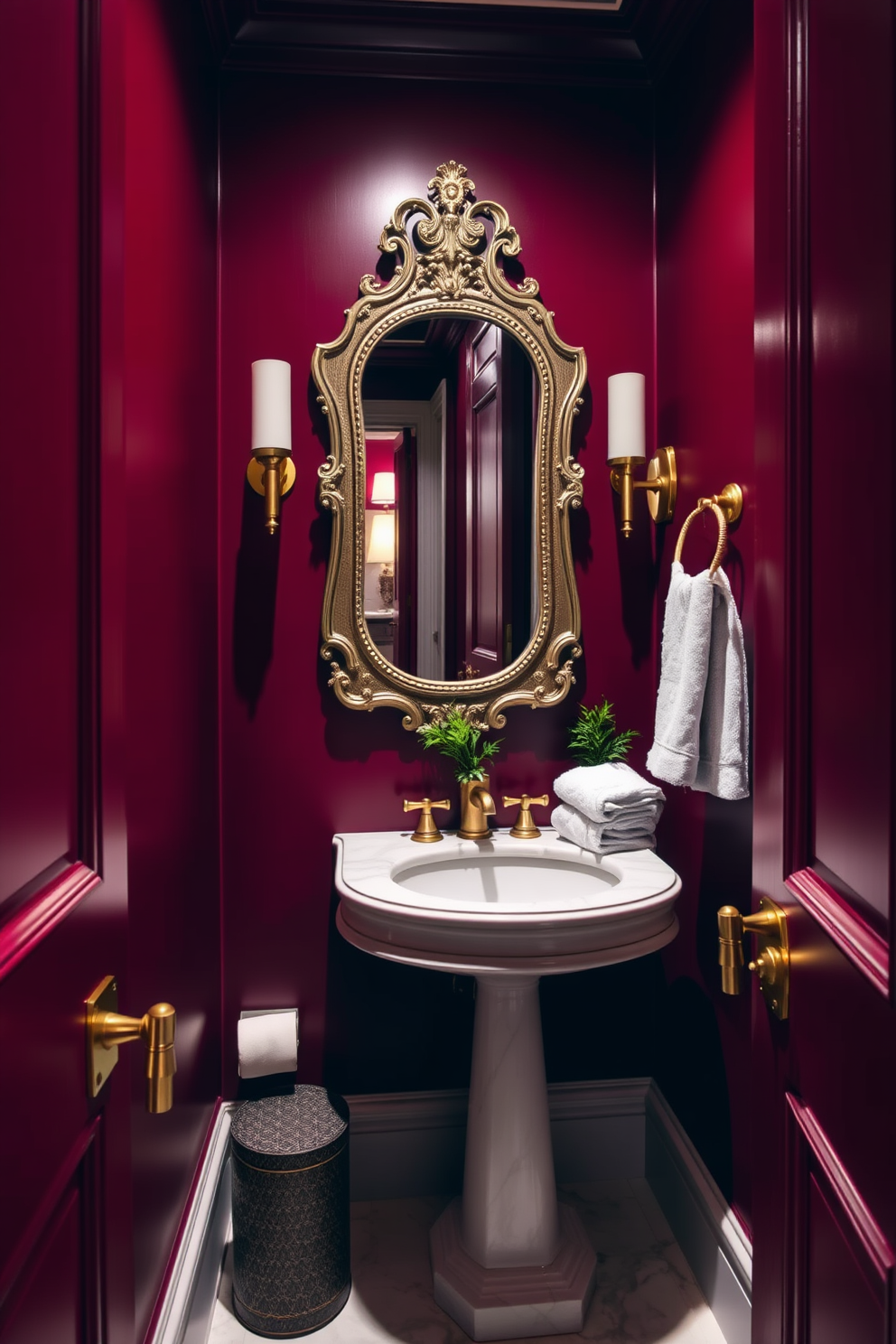 A luxurious powder room featuring rich burgundy walls that create an intimate and elegant atmosphere. The space is accented with gold fixtures and a white marble pedestal sink, enhancing the overall opulence. Soft lighting illuminates the room, highlighting decorative elements such as a vintage-style mirror and plush towels. A small potted plant adds a touch of greenery, complementing the deep color palette beautifully.