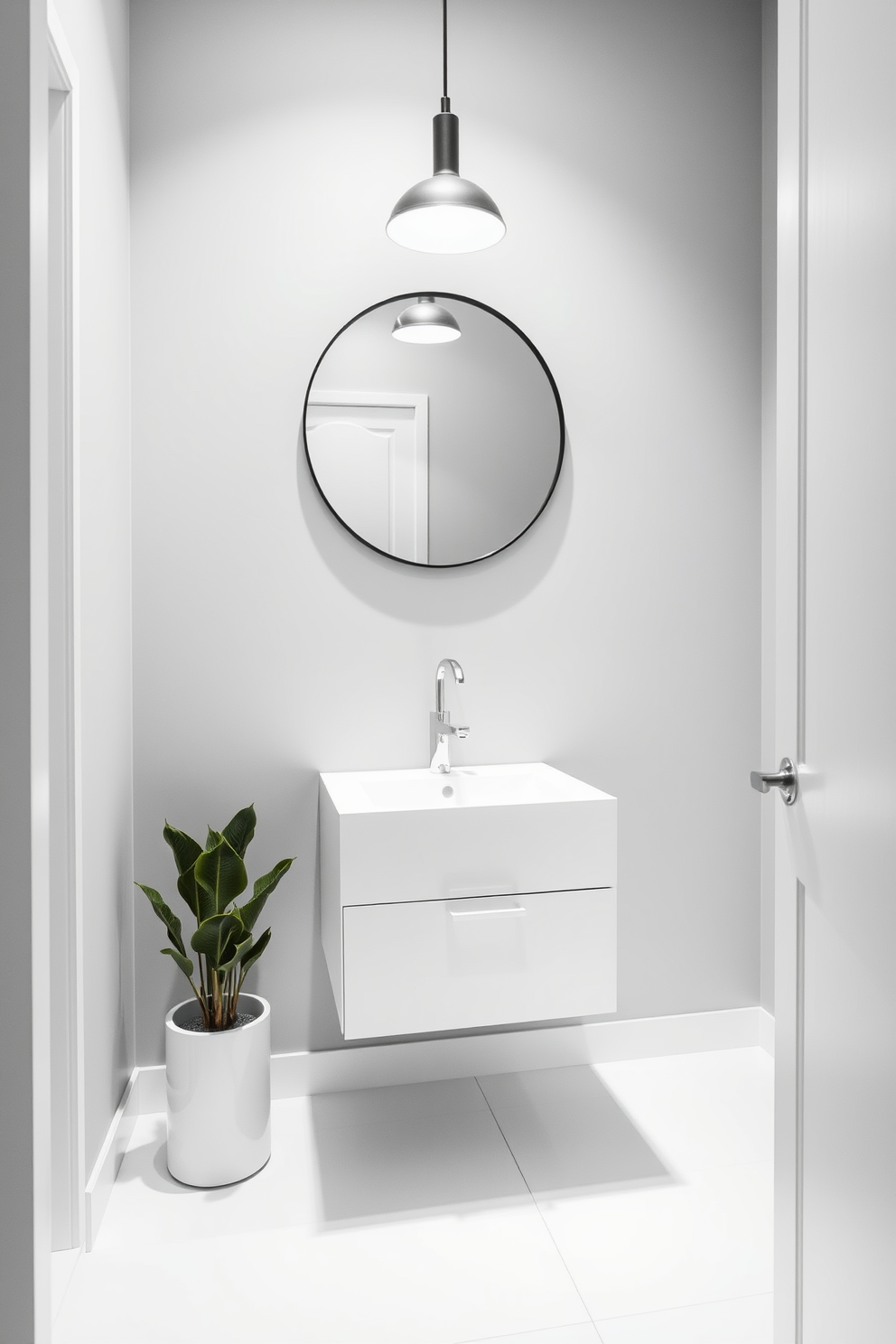 A soft gray powder room exudes modern minimalism with its sleek lines and understated elegance. The walls are painted in a soothing soft gray, complemented by a floating white vanity that features a simple rectangular sink and minimalist hardware. A large round mirror with a thin black frame hangs above the vanity, reflecting the gentle light from a stylish pendant fixture. The floor is adorned with large white tiles, creating a clean and spacious feel, while a small potted plant adds a touch of greenery to the serene atmosphere.