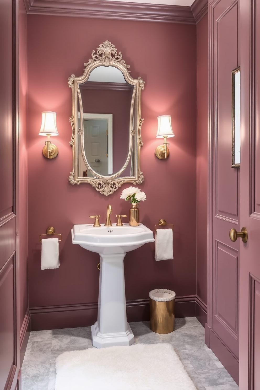 A refined powder room featuring muted mauve walls that exude elegance and warmth. The color complements a sleek white pedestal sink and a vintage-style mirror with intricate detailing. The flooring consists of light gray tiles that provide a subtle contrast to the walls. Accents of gold in the fixtures and a plush cream rug enhance the luxurious atmosphere.