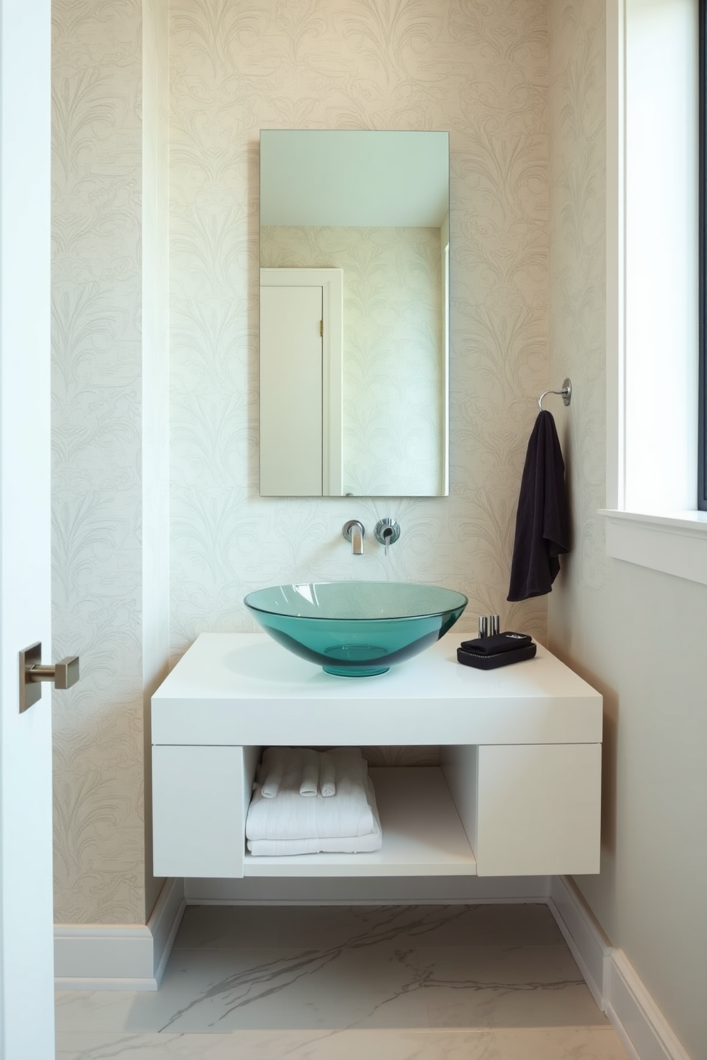 A sleek powder room features a stunning glass bowl sink that sits atop a minimalist floating vanity. The walls are adorned with elegant wallpaper in soft neutral tones, and the floor is finished with polished marble tiles.