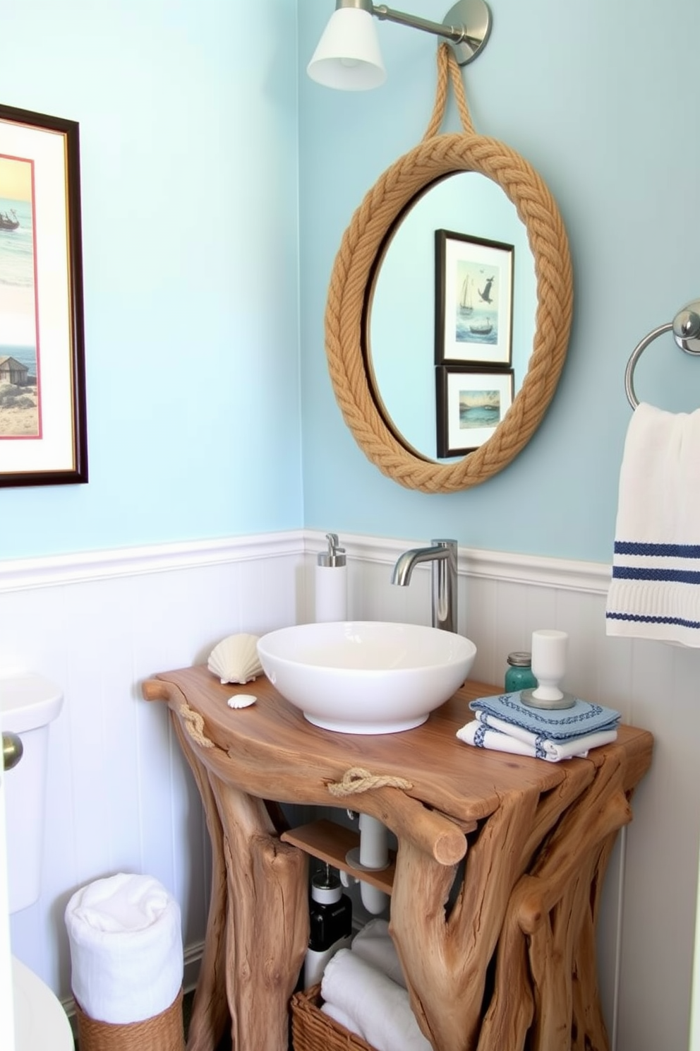 A nautical themed powder room featuring a unique vanity crafted from driftwood. The vanity includes a white vessel sink and is accented with marine-inspired decor such as seashells and rope details. The walls are painted in a soft ocean blue, creating a serene atmosphere. Nautical artwork and a round mirror with a rope frame complete the coastal vibe of the space.