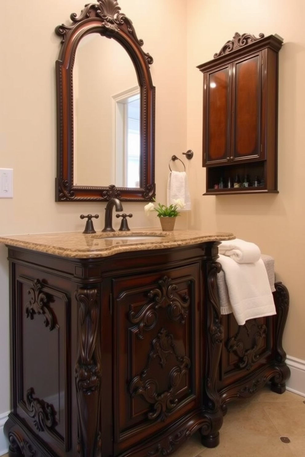 A traditional powder room featuring a stunning vanity with intricate ornate carvings and a rich dark wood finish. The countertop is adorned with a polished granite surface, complemented by a pair of vintage-style faucets and an elegant framed mirror above. The walls are painted in a soft cream hue, enhancing the warm ambiance of the space. Decorative elements include a small potted plant and plush hand towels neatly arranged on the vanity.