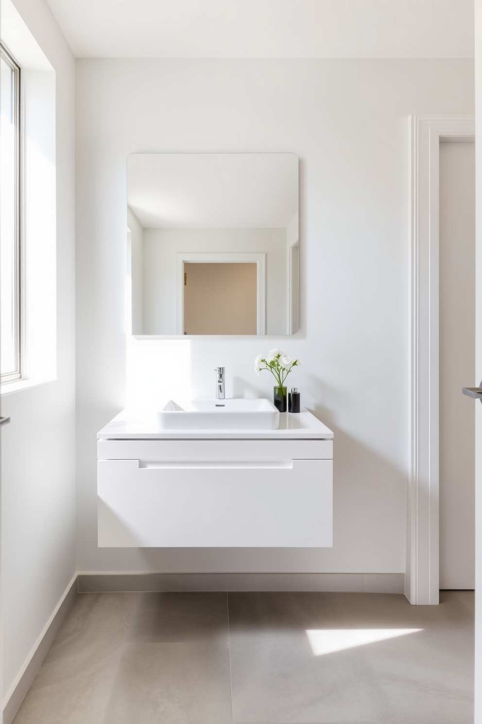 A minimalist wall-mounted vanity with clean lines is the focal point of this powder room. The vanity features a sleek white finish and a simple rectangular sink, enhancing the sense of space and tranquility. Above the vanity, a large frameless mirror reflects natural light, creating an airy ambiance. The walls are painted in a soft pastel hue, while the floor showcases light gray tiles for a cohesive and modern look.