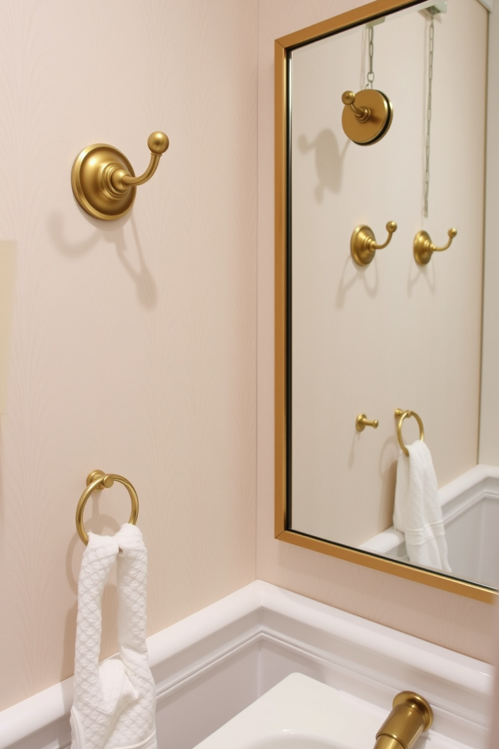 A stylish powder room featuring decorative wall hooks made of brushed brass, elegantly arranged to enhance functionality and aesthetics. The walls are adorned with a soft pastel wallpaper, creating a warm and inviting atmosphere while the hooks provide a practical solution for hanging towels and accessories.