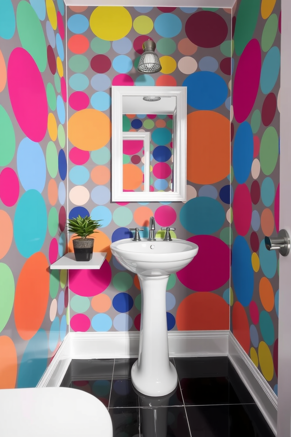 A vibrant powder room featuring bold polka dot wallpaper in a mix of bright colors. The playful design contrasts with sleek, modern fixtures including a chic pedestal sink and a minimalist mirror. The floor is adorned with glossy black tiles that enhance the lively atmosphere. A small potted plant sits on a floating shelf, adding a touch of greenery to the whimsical space.