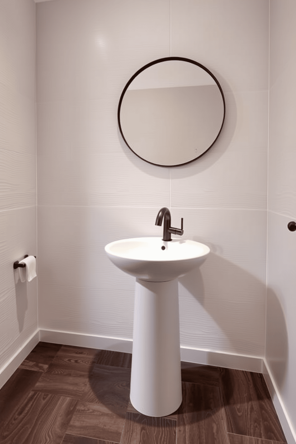 A stylish quarter bathroom featuring unique faucet designs as focal points. The walls are adorned with textured tiles in soft neutral tones, and the flooring consists of sleek, dark wood planks. A contemporary pedestal sink showcases an artistic faucet that draws the eye. A round mirror with a minimalist frame hangs above the sink, adding depth to the space.