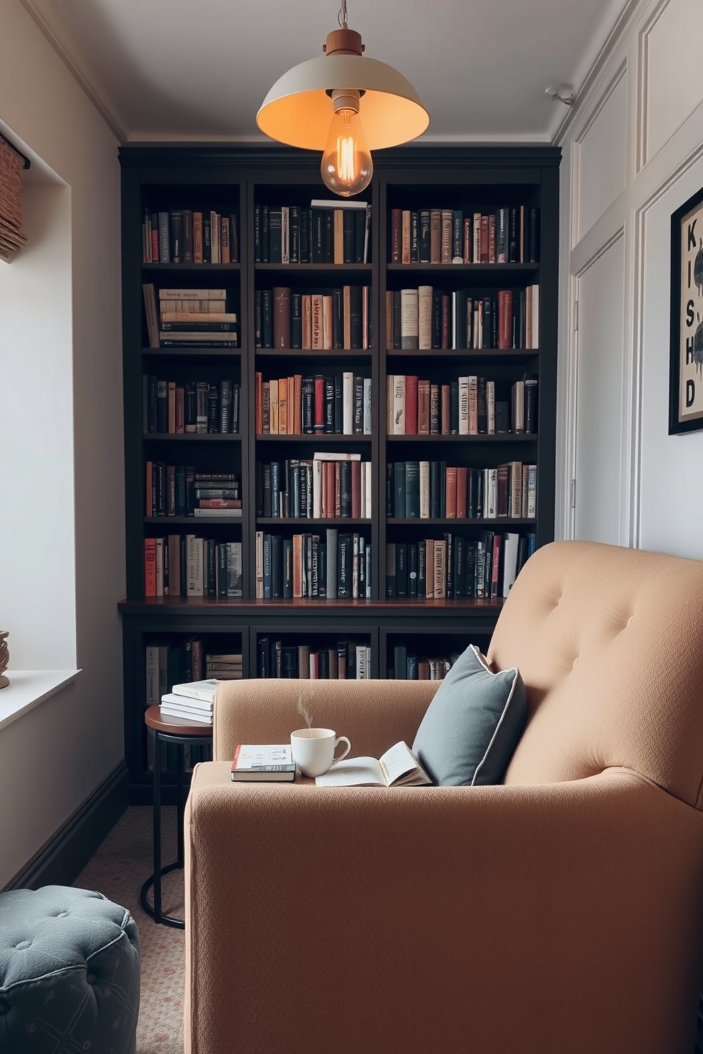 A cozy nook features an oversized armchair upholstered in soft, textured fabric. A small side table holds a steaming cup of tea and a stack of well-loved books, creating an inviting atmosphere. The walls are lined with built-in bookshelves filled with a mix of novels and decorative items. A warm, ambient light fixture hangs overhead, casting a gentle glow that enhances the room's tranquil feel.