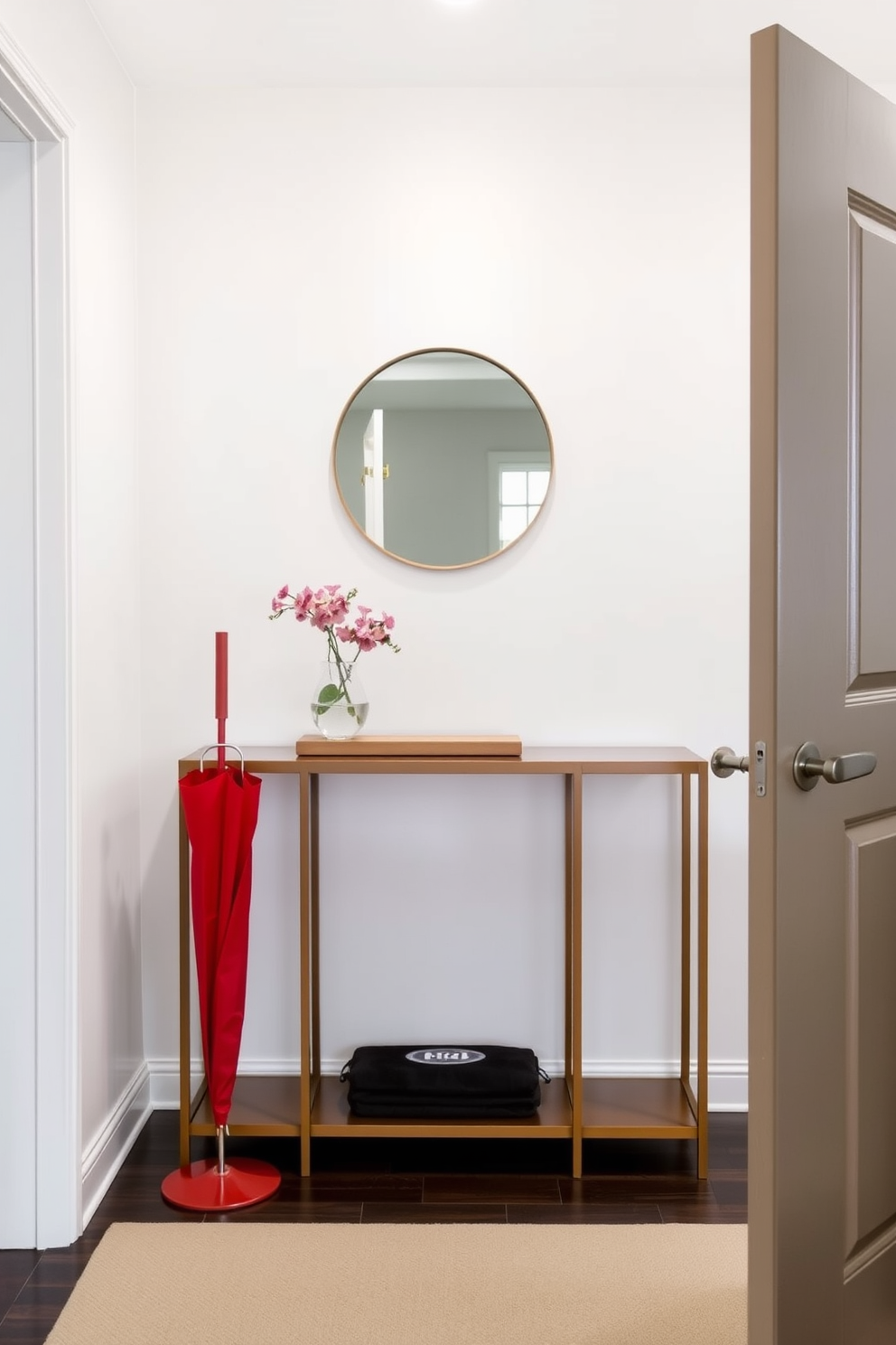 A bright red umbrella stand stands prominently by the door, adding a bold splash of color to the entryway. The foyer features a sleek console table with a minimalist design, topped with a round mirror that reflects light and creates a welcoming atmosphere.