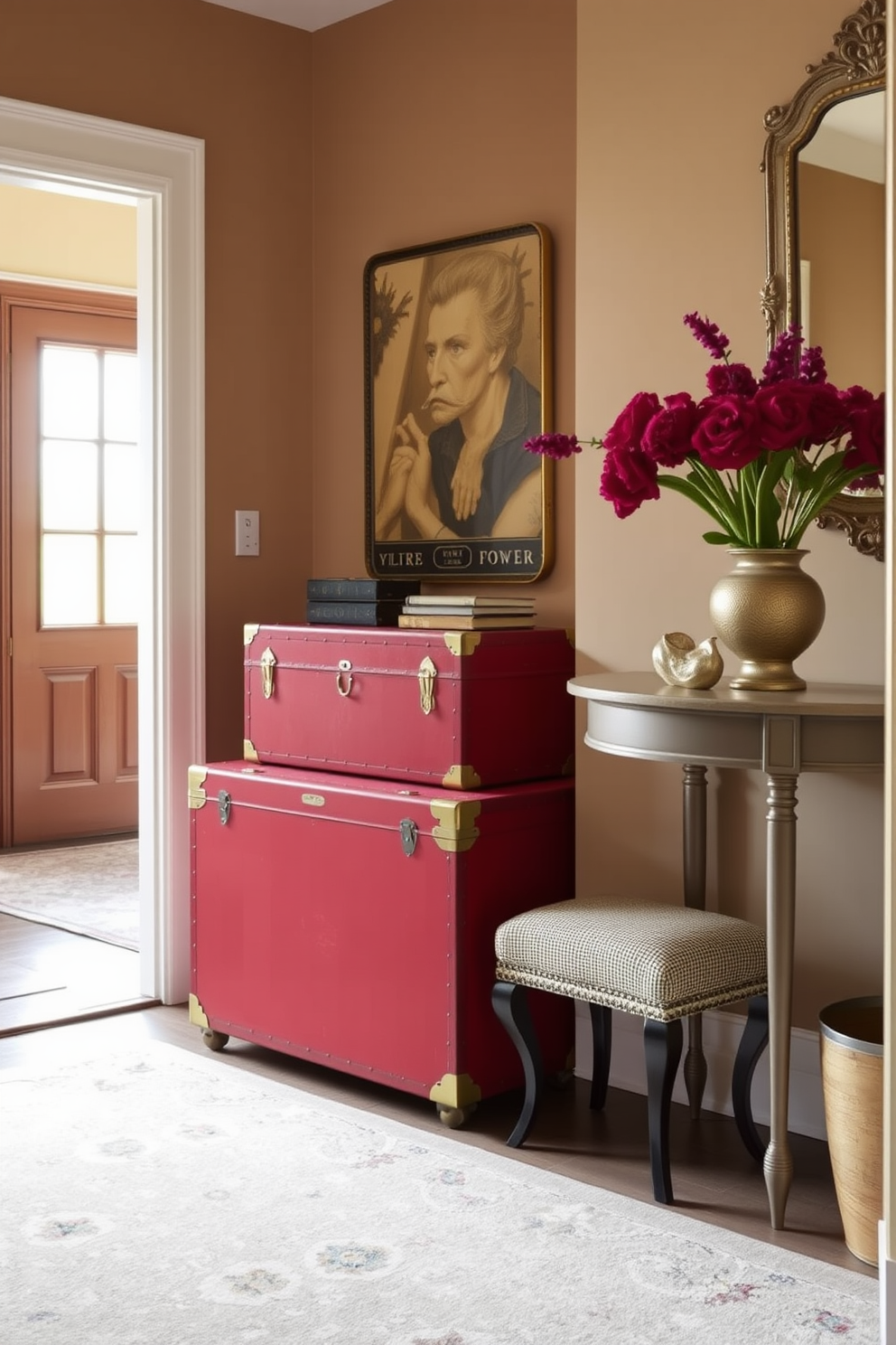 A vintage red trunk serves as a stylish storage solution in the foyer. The trunk is adorned with brass accents and sits against a backdrop of warm beige walls. Incorporating vintage elements, the foyer features a classic console table with a decorative mirror above it. A soft area rug in muted tones anchors the space, adding warmth and texture.