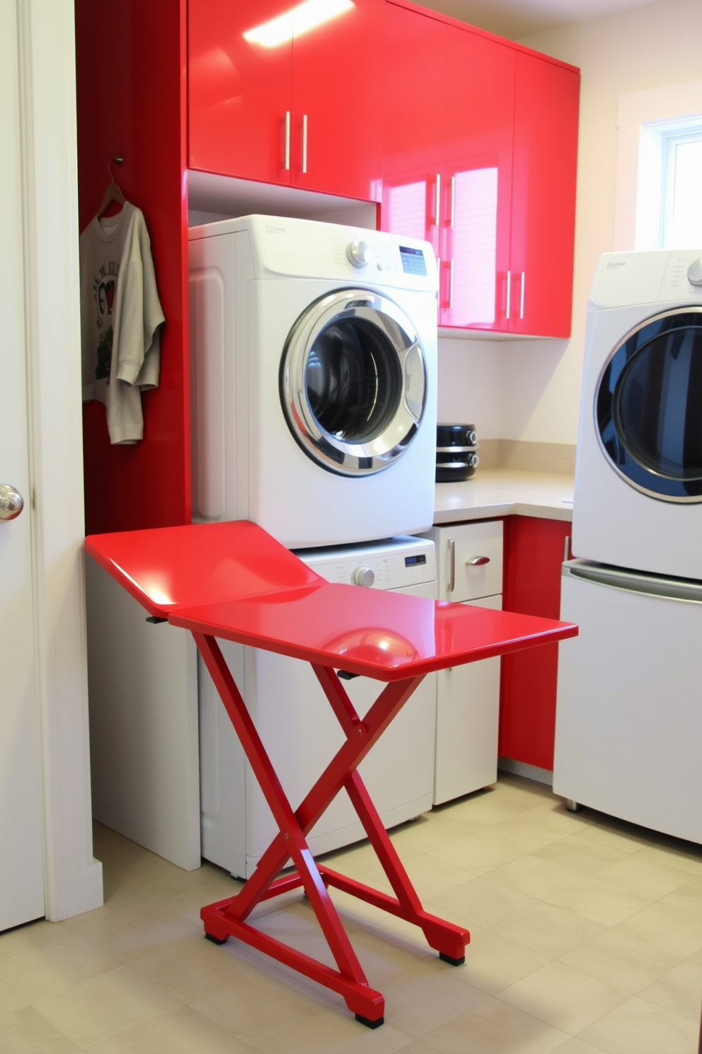 A stylish red folding table is positioned against the wall, offering a practical solution for laundry tasks. The table features a sleek design with a glossy finish, complementing the vibrant color and enhancing the room's overall aesthetic. The laundry room is designed with bright red cabinetry and modern appliances, creating an inviting and efficient workspace. A spacious countertop extends next to the washer and dryer, providing ample room for sorting and folding clothes.