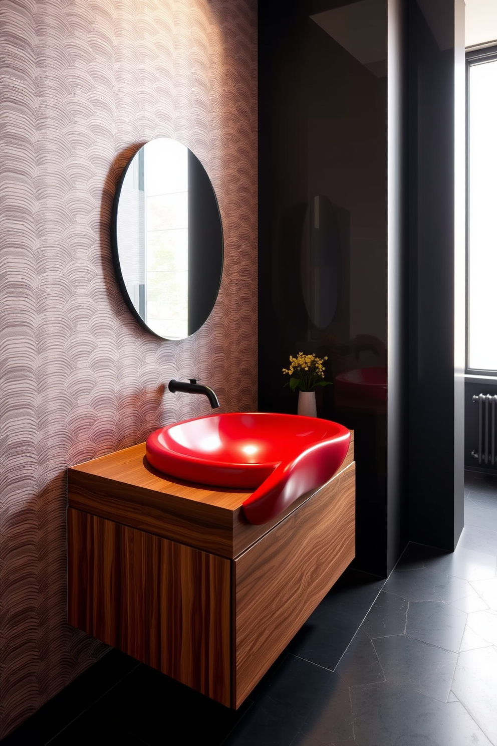 A striking modern red sink with a unique organic shape is the centerpiece of this stylish powder room. The walls are adorned with a sleek geometric wallpaper in complementary tones, while the floor features elegant dark tiles that enhance the overall design. The vanity is crafted from rich wood, providing a warm contrast to the bold red sink. A minimalist mirror with a thin black frame hangs above, reflecting the vibrant colors and modern aesthetics of the space.