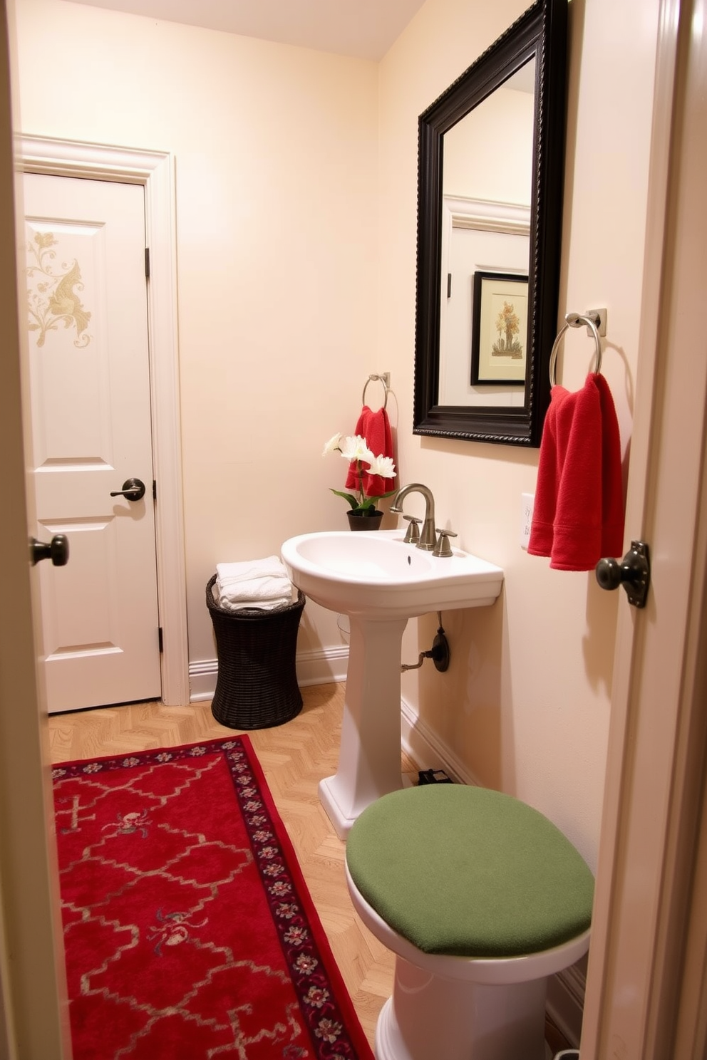 A cozy powder room featuring a striking red patterned area rug that adds warmth and vibrancy to the space. The walls are painted in a soft cream color, complementing the rich tones of the rug and creating an inviting atmosphere. The room includes a stylish pedestal sink with a vintage faucet, accented by a framed mirror above it. Decorative elements such as a small potted plant and elegant hand towels in coordinating colors enhance the overall design.