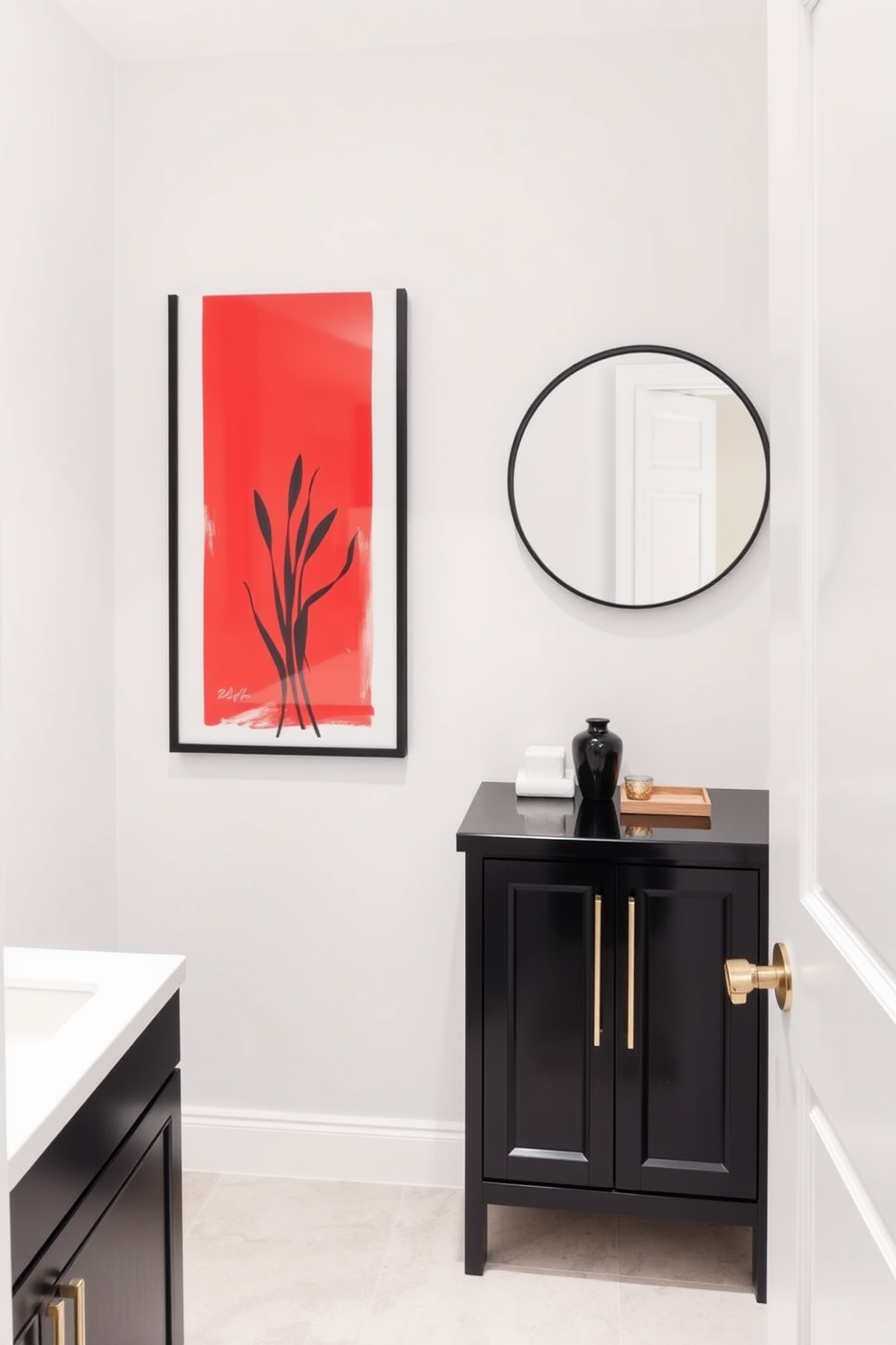 Contemporary red artwork serves as a striking focal point in this chic powder room. The walls are painted in a soft white, allowing the vibrant artwork to stand out beautifully. The room features a sleek black vanity with a polished white countertop. A round mirror with a thin black frame hangs above the vanity, reflecting the bold colors of the space.