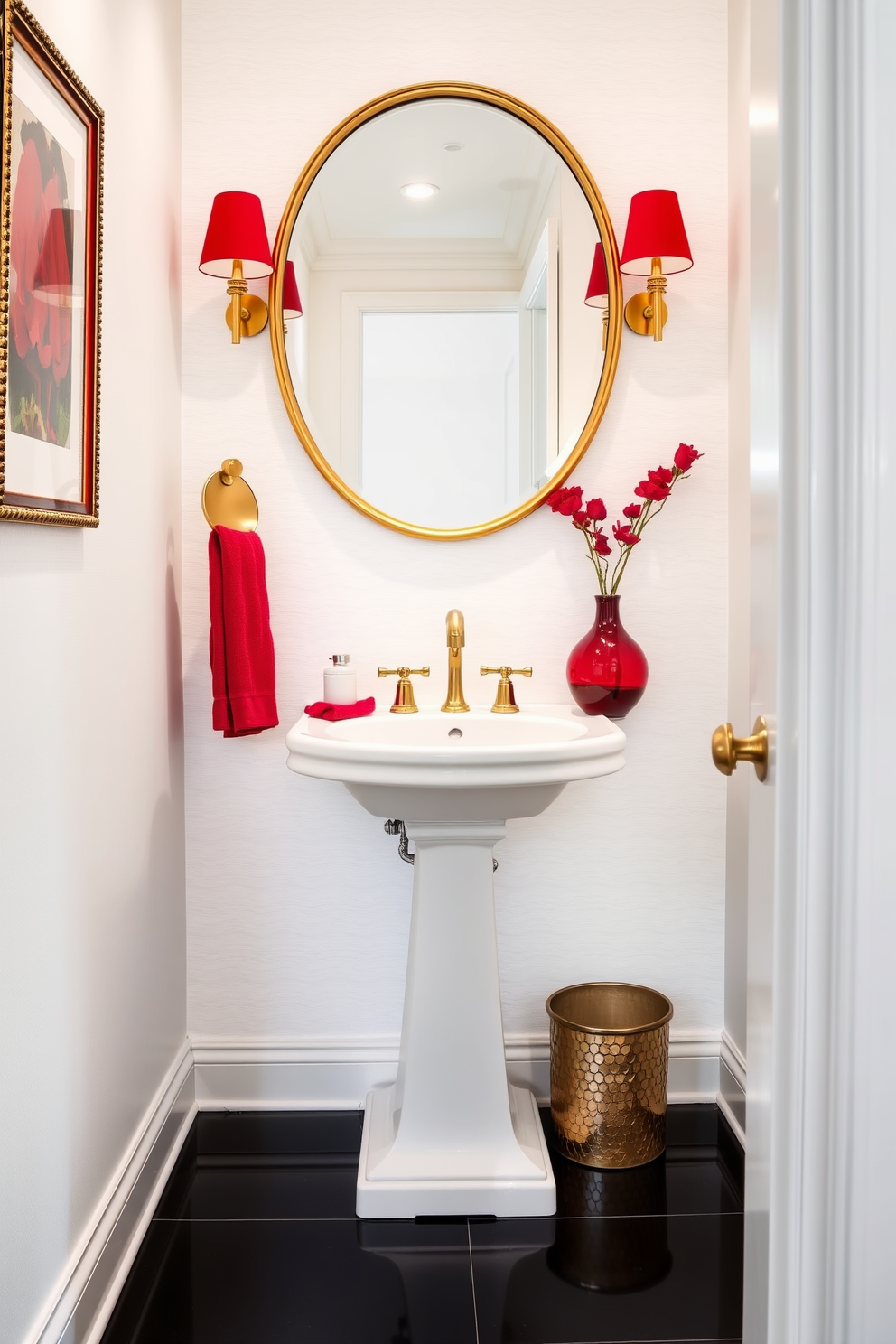 A striking powder room featuring a white pedestal sink with gold fixtures. The walls are adorned with a subtle white wallpaper, and bold red accessories, including a vibrant red towel and a decorative vase, add a pop of color. The floor is covered in sleek black tiles that contrast beautifully with the white decor. A large round mirror with a gold frame hangs above the sink, enhancing the elegance of the space.