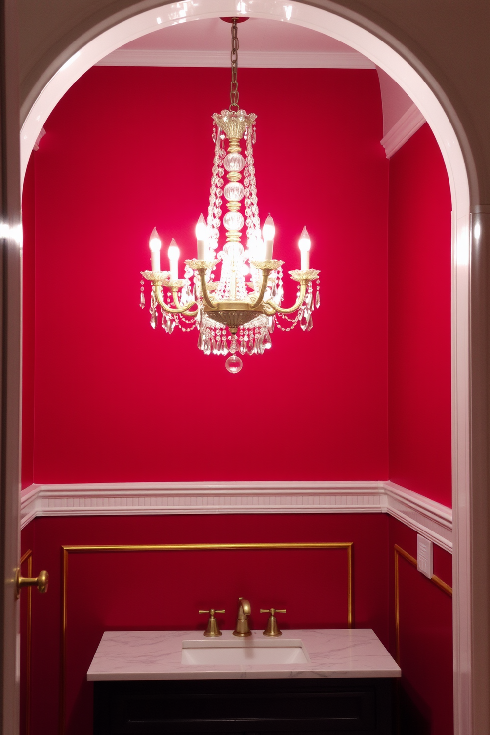 An elegant chandelier hangs gracefully from the ceiling, its crystals reflecting light in a dazzling display. The backdrop is a rich red, creating a bold and luxurious atmosphere in the powder room. The walls are adorned with intricate gold accents that complement the chandelier's opulence. A sleek black vanity with a white marble countertop adds a modern touch to this sophisticated space.