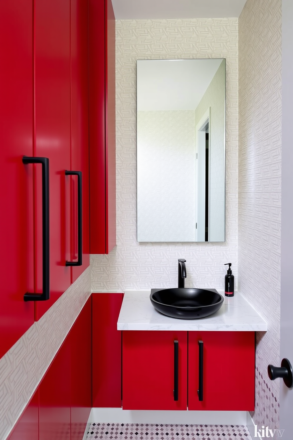 A sleek red powder room features modern cabinets with black hardware that create a striking contrast. The walls are adorned with a subtle geometric wallpaper that complements the bold cabinetry, while a stylish black sink adds to the contemporary feel.