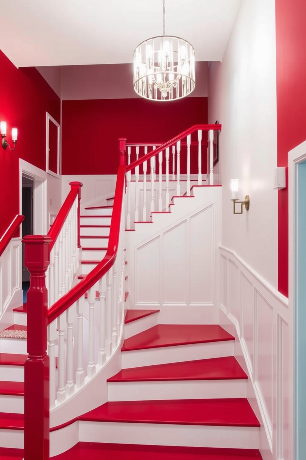 A stunning two-tone red and white staircase features a bold red railing that contrasts beautifully with the crisp white balusters. The steps are painted in a deep red, while the risers are a clean white, creating a striking visual effect as light cascades down the staircase. The staircase is illuminated by a modern chandelier that hangs gracefully above, casting a warm glow on the vibrant colors. Surrounding the staircase are elegant wall sconces that enhance the overall ambiance of the space.