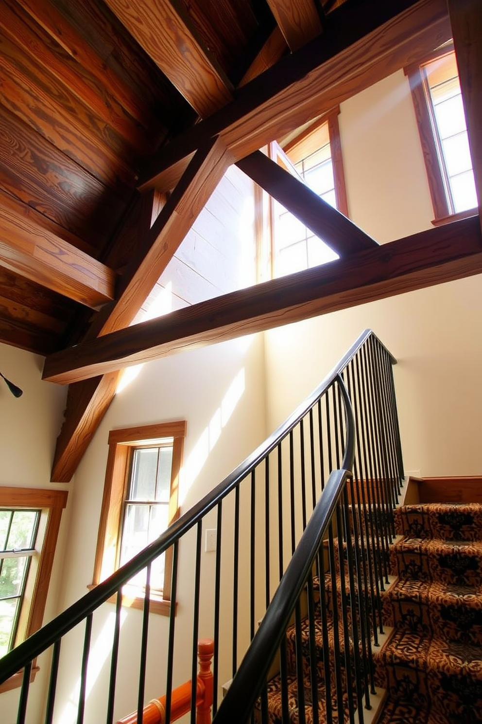 A rustic staircase features exposed wood beams that create a warm and inviting atmosphere. The wood beams are complemented by a handrail made of wrought iron, enhancing the vintage charm of the design. The staircase is adorned with patterned runner carpet that adds a touch of color and texture. Natural light pours in from a nearby window, illuminating the rich tones of the wood and creating a cozy ambiance.