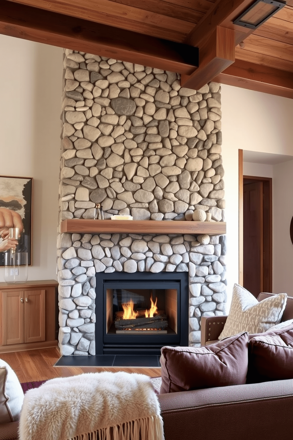 A cozy fireplace serves as the focal point of the living area, surrounded by a stone feature wall that adds warmth and texture. Comfortable seating with plush cushions and a soft throw blanket invites relaxation, while wooden beams overhead enhance the rustic charm of the apartment.