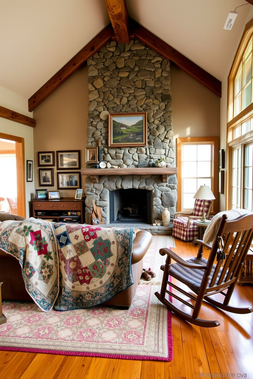 A cozy family room features vintage quilts draped over a worn leather sofa and a wooden rocking chair. The walls are adorned with family photos in rustic frames, and a large stone fireplace serves as the room's focal point. The floor is covered with a soft, patterned area rug that complements the quilts. Natural light streams in through large windows, illuminating the warm, earthy tones of the wooden beams and furniture.