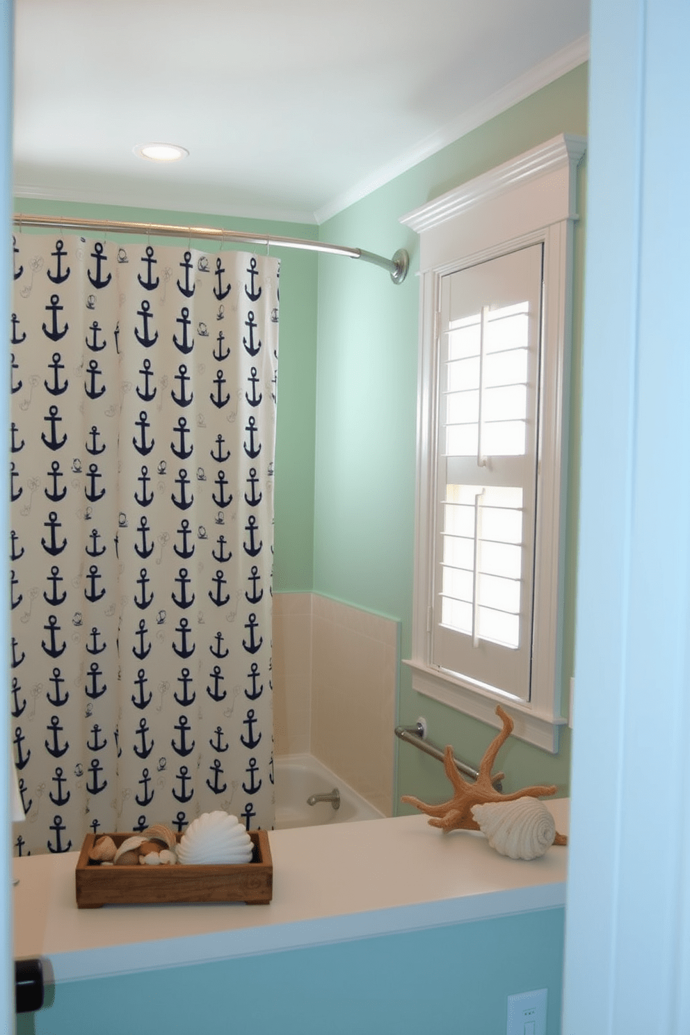 A serene beach-inspired bathroom featuring a nautical theme. The walls are painted in a soft seafoam green, and accents of navy blue are incorporated through decorative elements. A shower curtain adorned with a whimsical anchor pattern hangs gracefully in front of a large window. Complementing the curtain, a collection of seashells and driftwood decor is placed on the countertop for a touch of coastal charm.