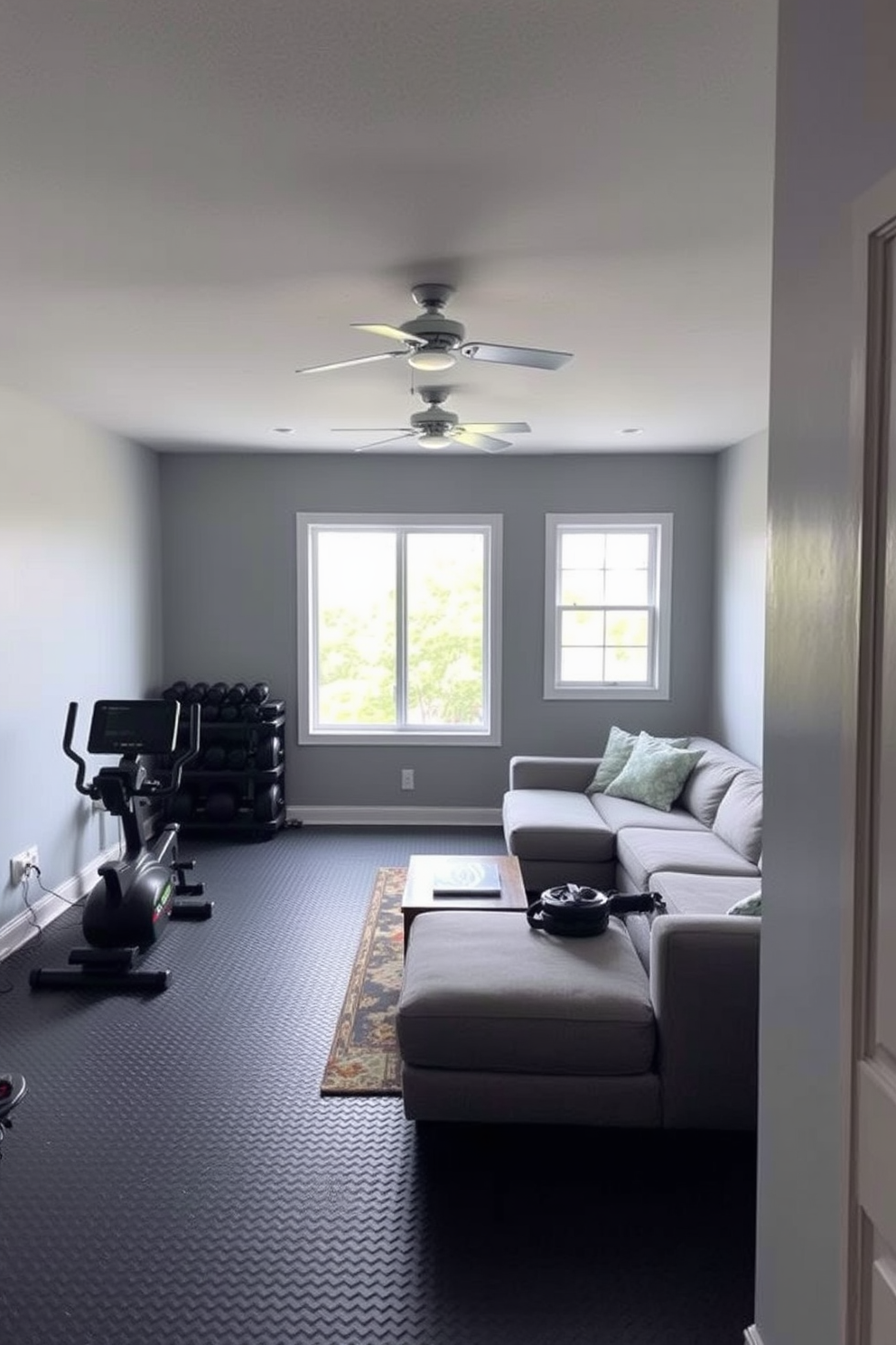 Create a workout space with equipment. The room features a large window allowing natural light to flood in, with rubber flooring for safety and comfort. Simple basement design ideas include a cozy lounge area with a sectional sofa and a coffee table. The walls are painted in a light gray color to create an open and inviting atmosphere.