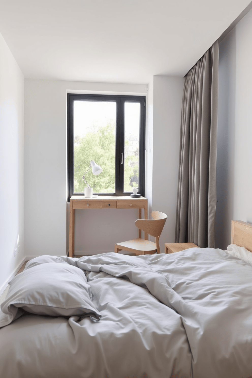 A cozy bedroom featuring a small desk positioned against the wall, creating a functional workspace. The bed is dressed in soft linens, with a neutral color palette that includes light gray and white accents. The desk is made of light wood with a minimalist design, complemented by a comfortable chair. Natural light pours in through a large window, enhancing the serene atmosphere of the room.