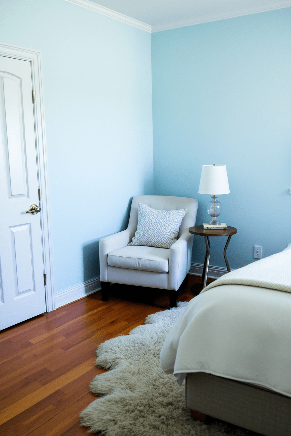 A cozy bedroom featuring a soft plush chair nestled in the corner beside a small side table. The walls are painted in a calming light blue, and a fluffy area rug lies on the hardwood floor, adding warmth to the space.