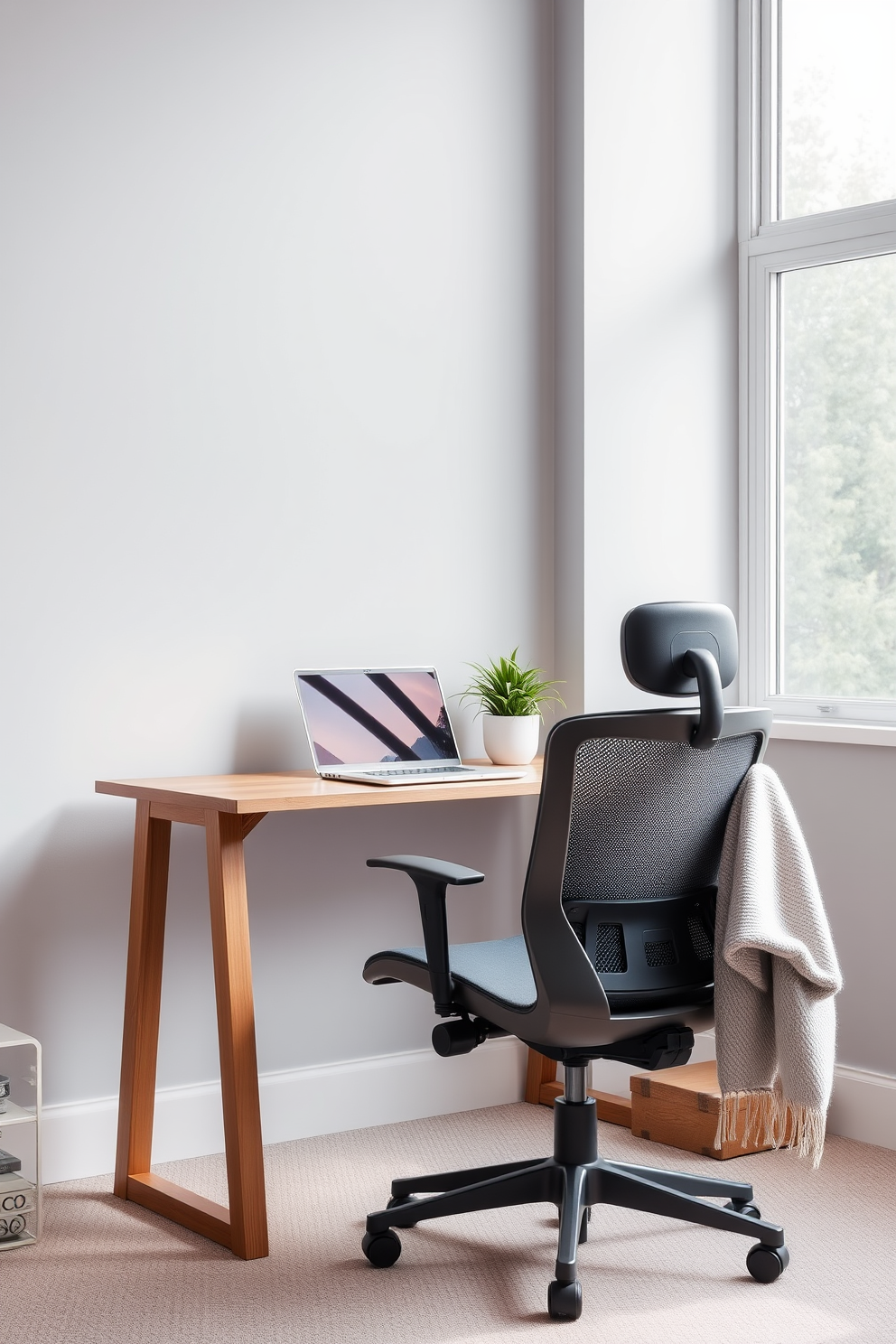 A cozy home office space featuring a sleek wooden desk with a modern ergonomic chair. The walls are painted in a soft gray hue, and a large window allows natural light to fill the room. On the desk, a stylish laptop sits next to a decorative plant in a ceramic pot. A comfortable throw blanket is draped over the back of the chair, adding warmth and inviting comfort to the workspace.