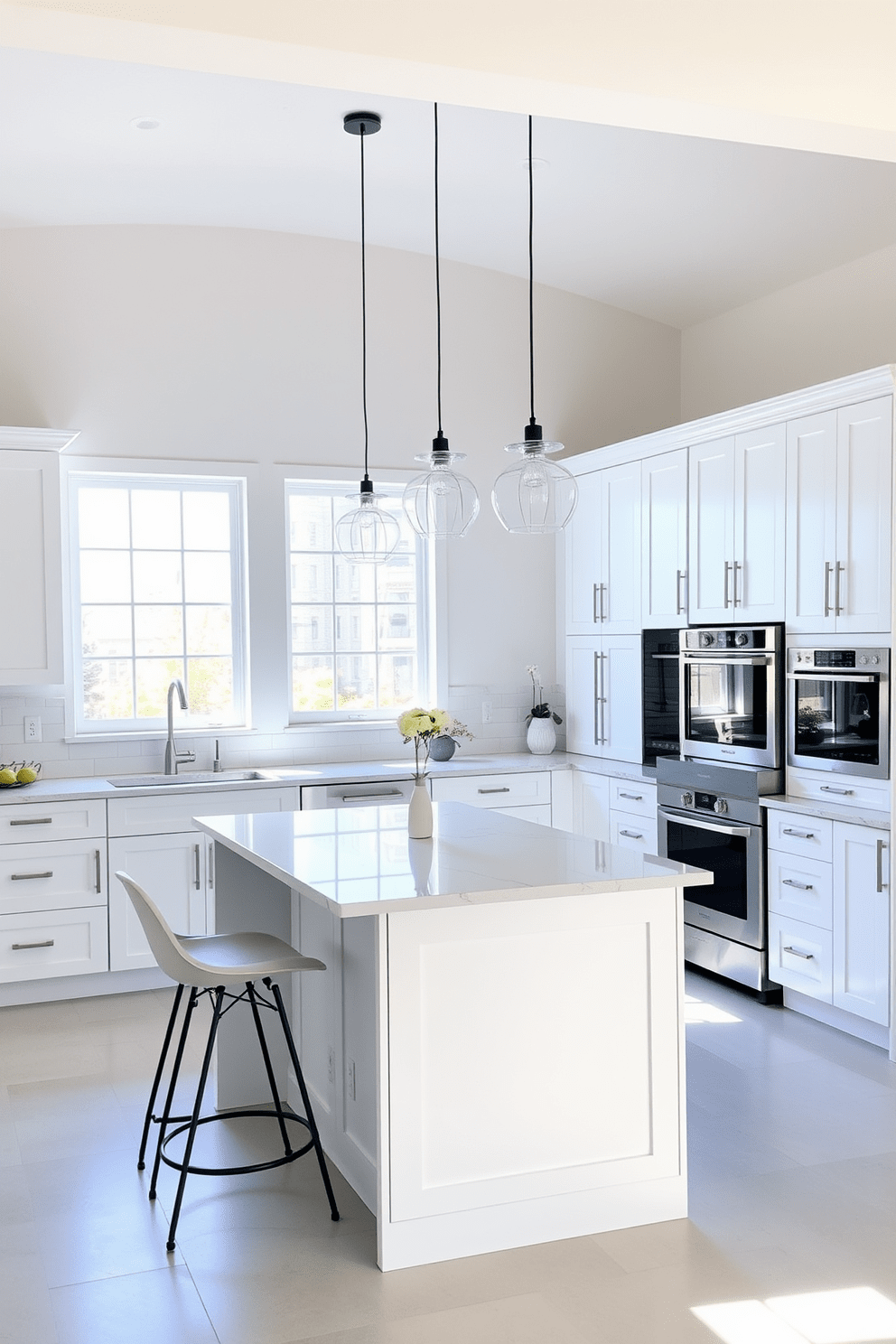 A bright and airy kitchen space featuring white cabinetry with sleek handles and a light gray backsplash. A central island with a quartz countertop provides additional workspace and seating, complemented by stylish bar stools. Natural light floods the room through large windows, illuminating the open layout. Decorative pendant lights hang above the island, adding a modern touch to the overall design.