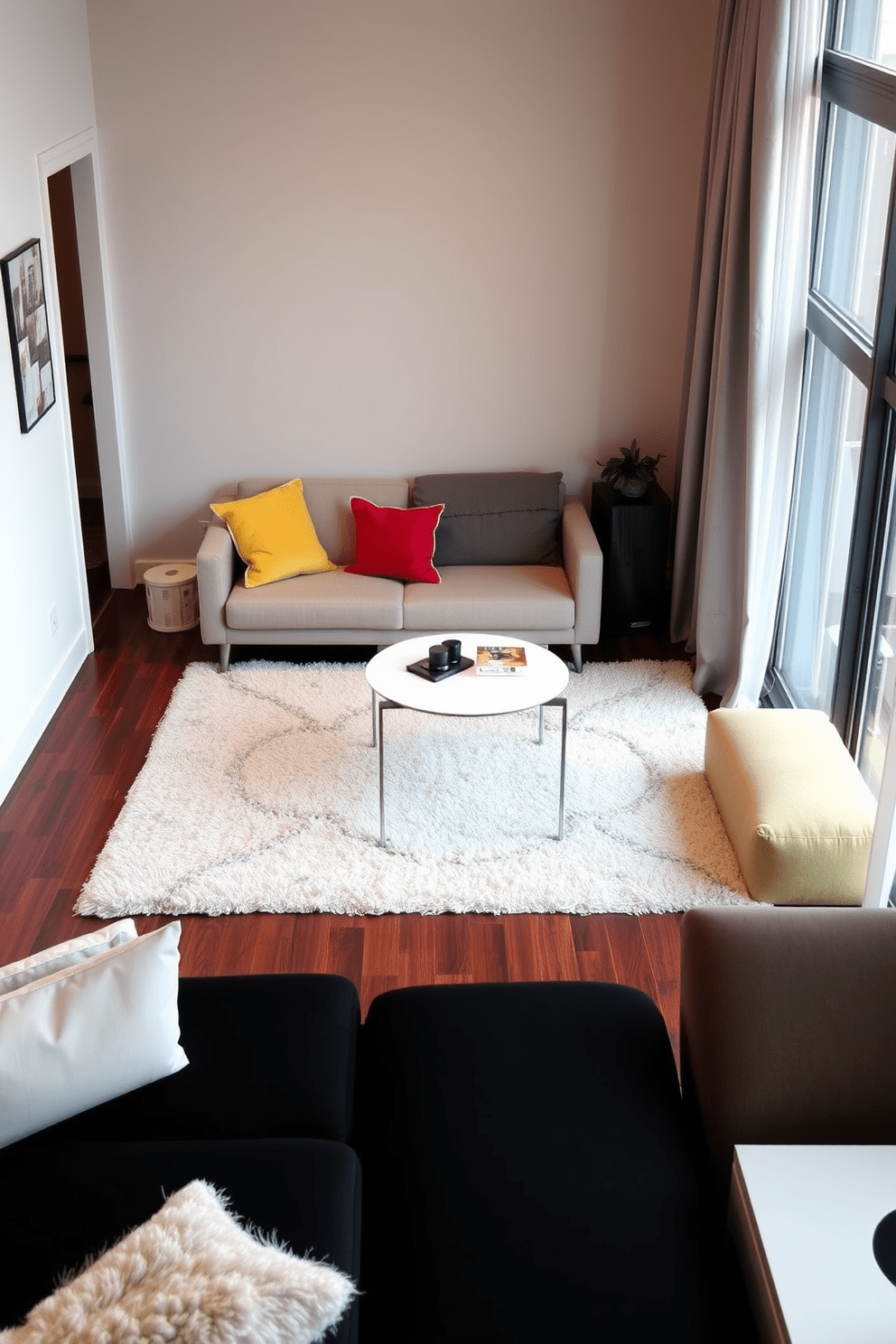 A cozy living area in a small apartment featuring a soft area rug that defines the seating space. The rug complements a modern sofa adorned with colorful cushions, and a sleek coffee table sits in the center. A compact dining nook with an elegant area rug under a round table. Surrounding the table are stylish chairs, creating an inviting atmosphere for meals and gatherings.