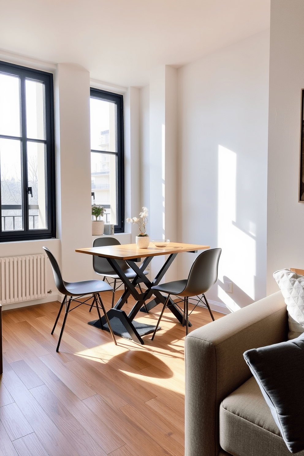 A cozy dining area featuring a foldable dining table that can be easily tucked away when not in use. Surrounding the table are four stylish chairs that complement the modern decor of the small apartment. The walls are painted in a light neutral tone to create an open and airy feel. Large windows allow natural light to flood the space, enhancing the warmth of the wooden flooring.