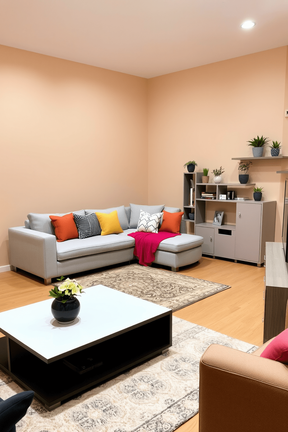 A cozy small apartment living room featuring a stylish sectional sofa in a light gray fabric. The sofa is adorned with colorful throw pillows, and a sleek coffee table sits in front, complemented by a soft area rug underneath. The walls are painted in a warm beige tone, creating an inviting atmosphere. A compact entertainment unit is positioned against one wall, with decorative shelves showcasing plants and books.