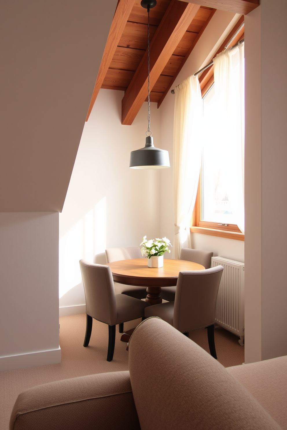 A cozy small dining nook nestled in the corner of an attic. The space features a round wooden table surrounded by upholstered chairs, with a pendant light hanging above to create a warm ambiance. The walls are painted in a soft white, complemented by exposed wooden beams for a rustic touch. A large window allows natural light to flood in, adorned with sheer curtains that gently filter the sunlight.