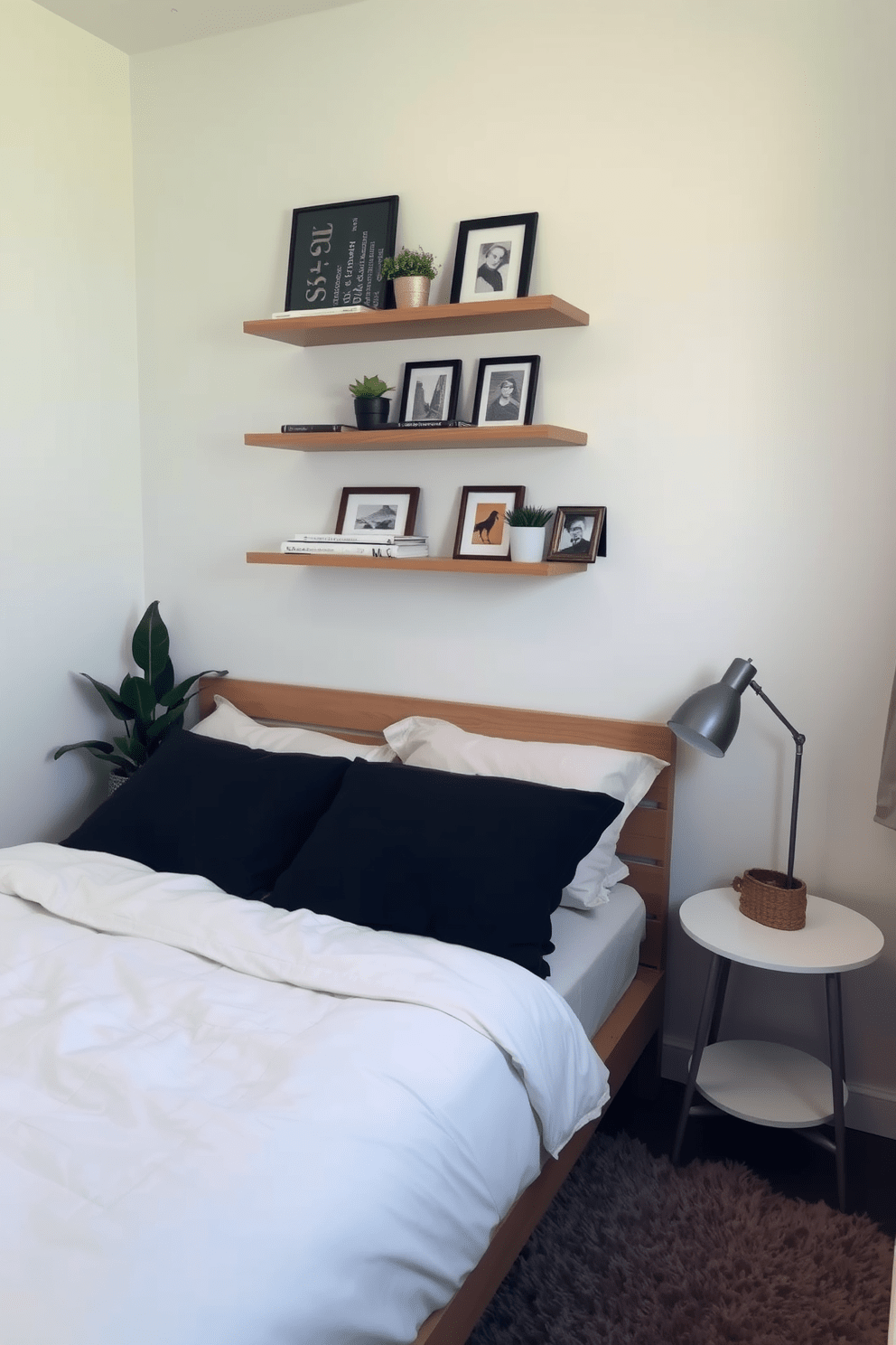 A cozy small bedroom featuring a neatly made bed with soft linens. Above the bed, floating shelves are mounted on the wall, adorned with decorative books, plants, and framed photos. The walls are painted in a light pastel color to create an airy feel. A small bedside table with a lamp complements the design, while a plush area rug adds warmth to the space.