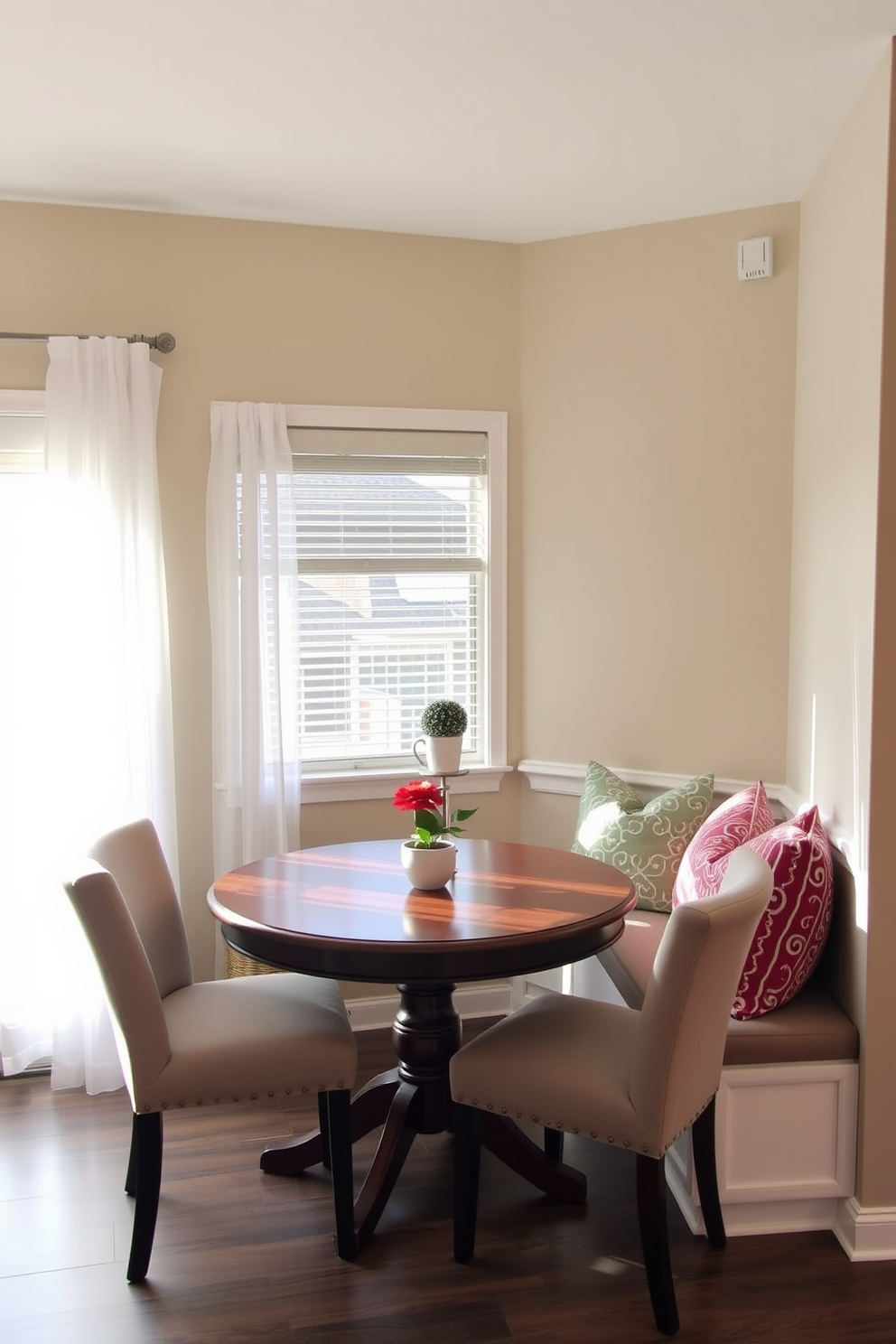 Create a cozy breakfast nook in a corner featuring a round wooden table surrounded by upholstered chairs. Soft, natural light filters through a nearby window adorned with sheer white curtains, creating an inviting atmosphere. Incorporate a built-in bench with colorful throw pillows against the wall to maximize space. The walls are painted in a warm neutral tone, and a small potted plant adds a touch of greenery to the setting.