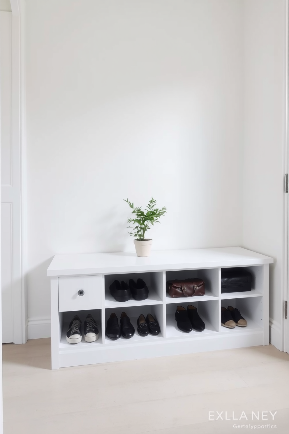 A minimalist bench with clean lines is positioned against the wall in a small entryway. Underneath the bench, there is ample storage space for shoes and bags, keeping the area organized and clutter-free. The walls are painted in a soft neutral tone, enhancing the sense of openness. A small potted plant sits on the bench, adding a touch of greenery and warmth to the design.