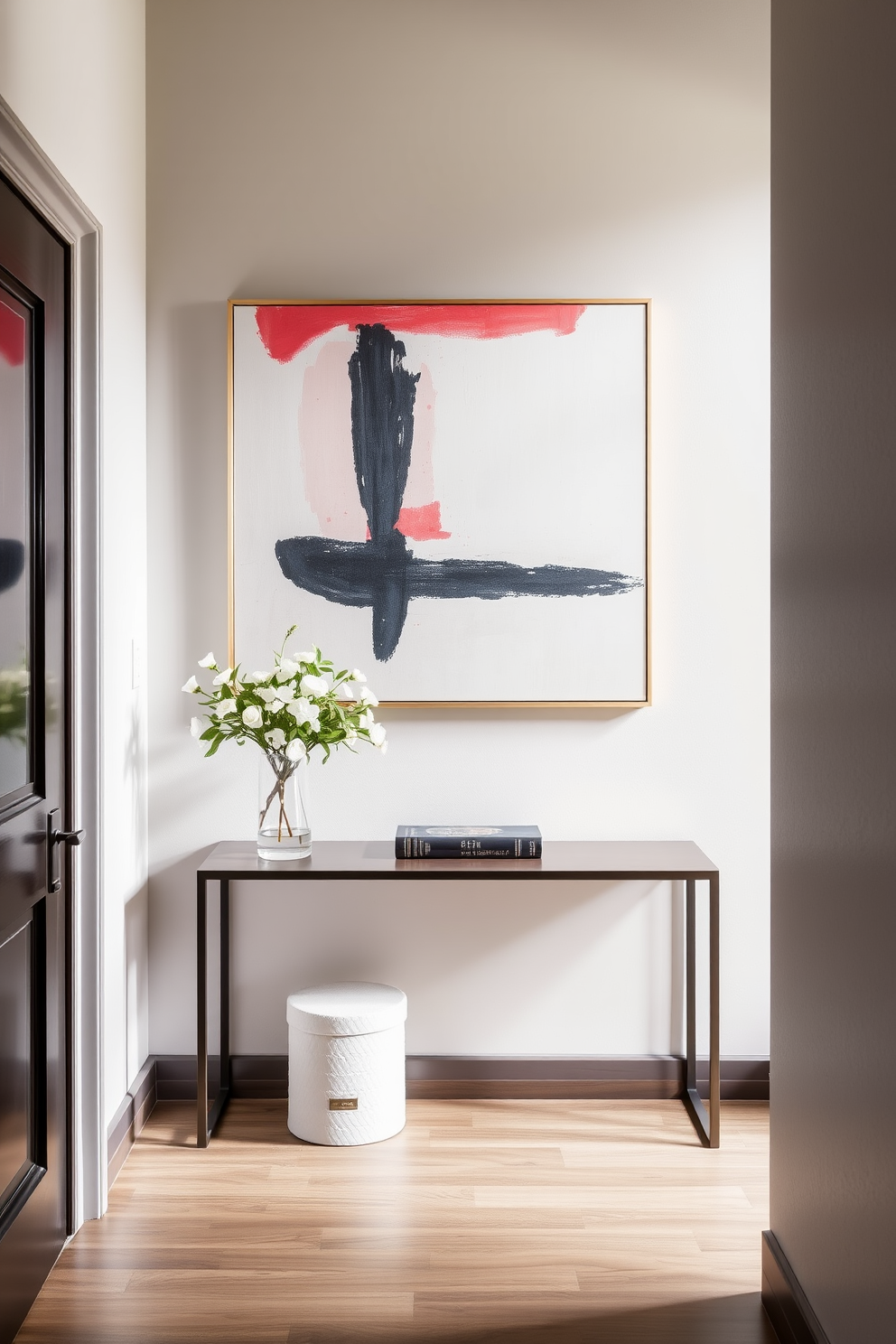 A stylish small entryway featuring a sleek console table against the wall. Above the console, a large piece of abstract artwork adds a pop of color and visual interest to the space.