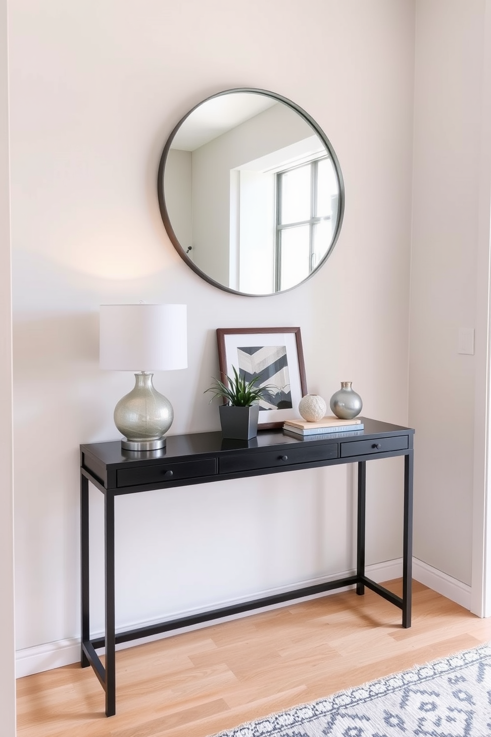 A narrow console table is positioned against the wall in a small entryway. It is adorned with decorative accents such as a stylish lamp, a small potted plant, and a framed artwork above it. The walls are painted in a soft neutral tone, enhancing the sense of space. A round mirror hangs above the console table, reflecting light and creating an inviting atmosphere.