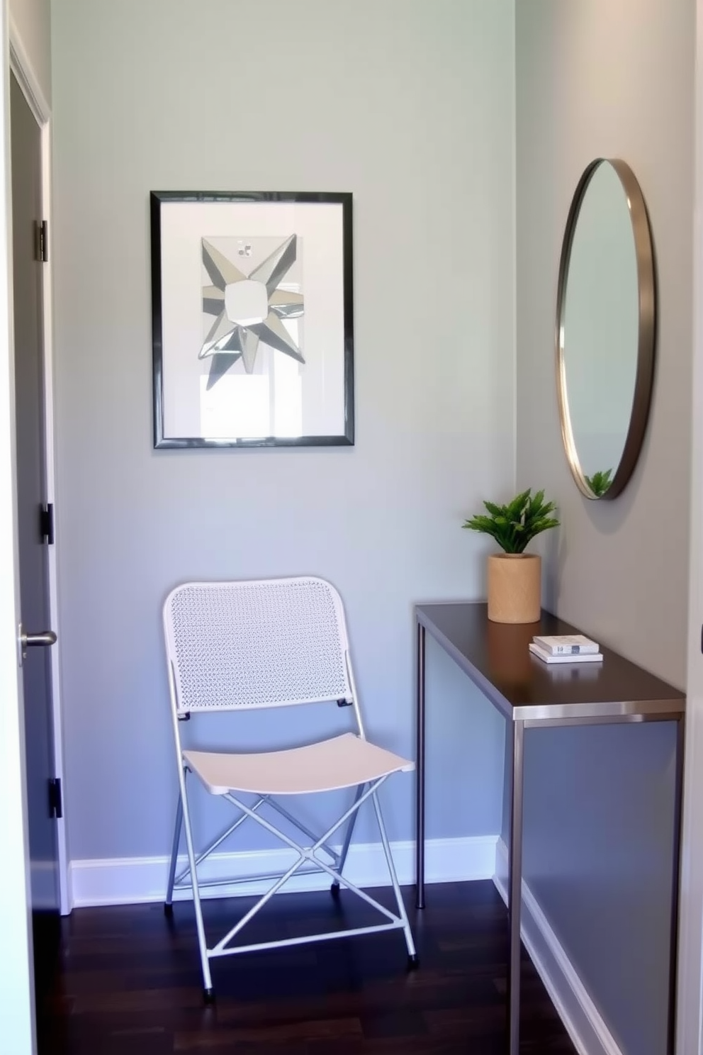 A small foyer features a sleek folding chair that can be easily tucked away when not in use. The walls are painted in a soft gray, complemented by a minimalist console table adorned with a small potted plant and a decorative mirror.