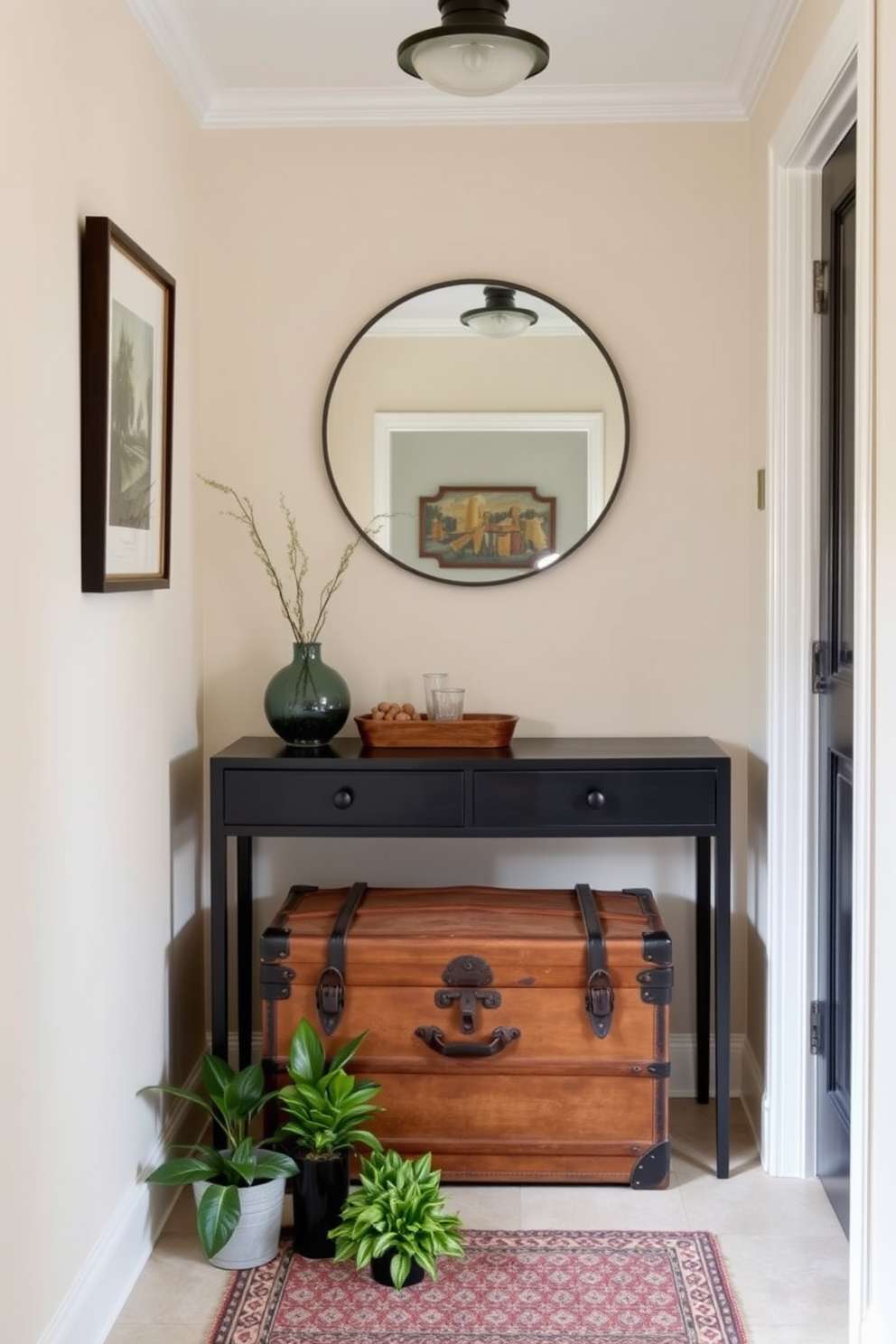 A charming small foyer features a vintage trunk as a focal point, adding character and warmth to the space. The walls are painted in a soft cream color, complemented by a stylish console table against one side. A large round mirror hangs above the console table, reflecting light and creating an illusion of more space. Potted plants are placed on the floor beside the trunk, bringing a touch of nature indoors.